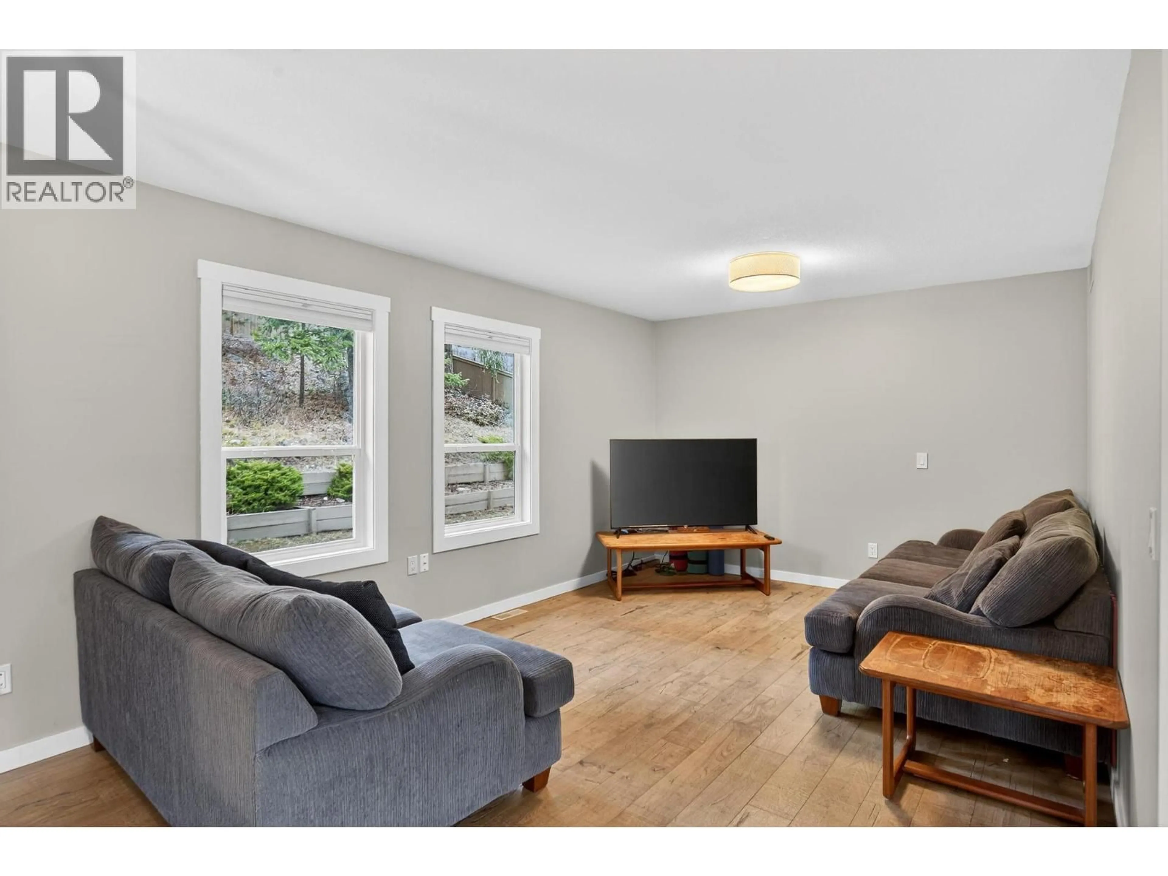 Living room with furniture, wood/laminate floor for 3190 MCLEOD ROAD, West Kelowna British Columbia V4T1A6