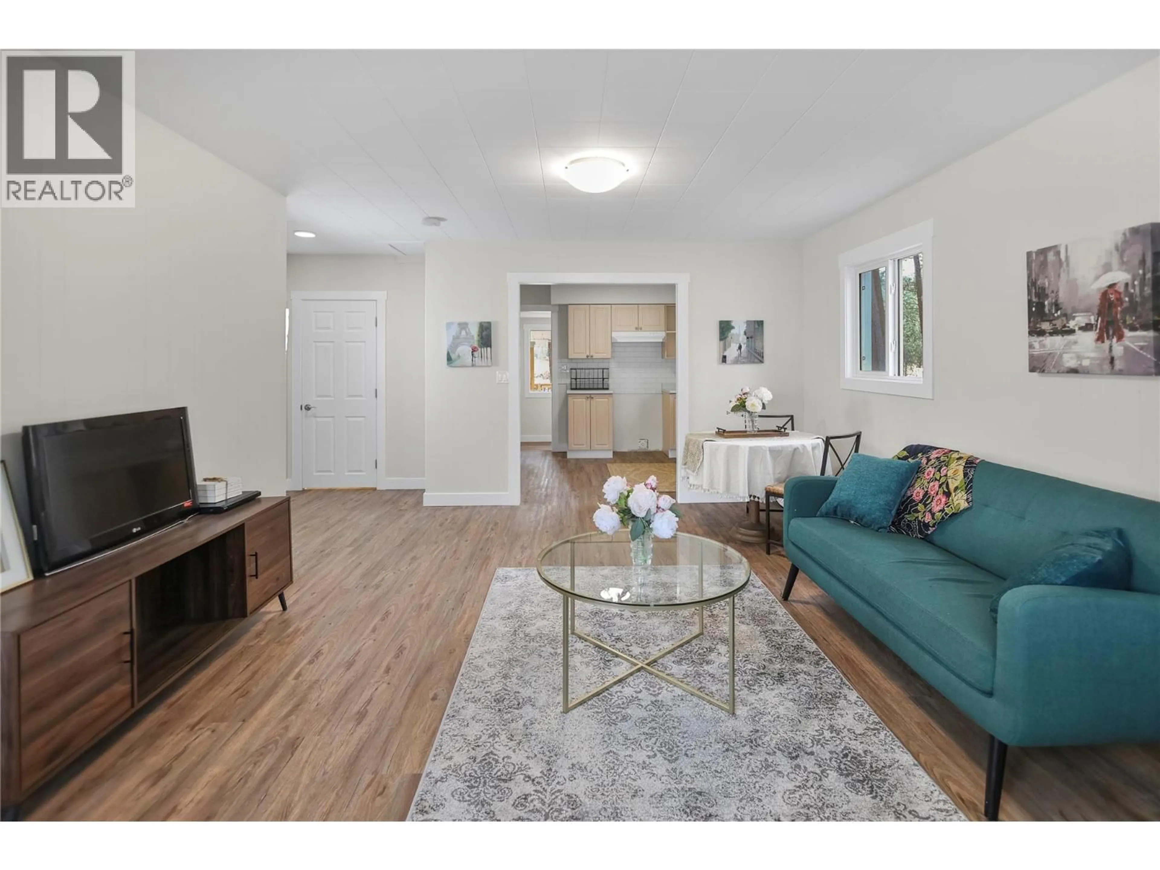 Living room with furniture, wood/laminate floor for 8127 DONALDSON DRIVE, Grand Forks British Columbia V0H1H2