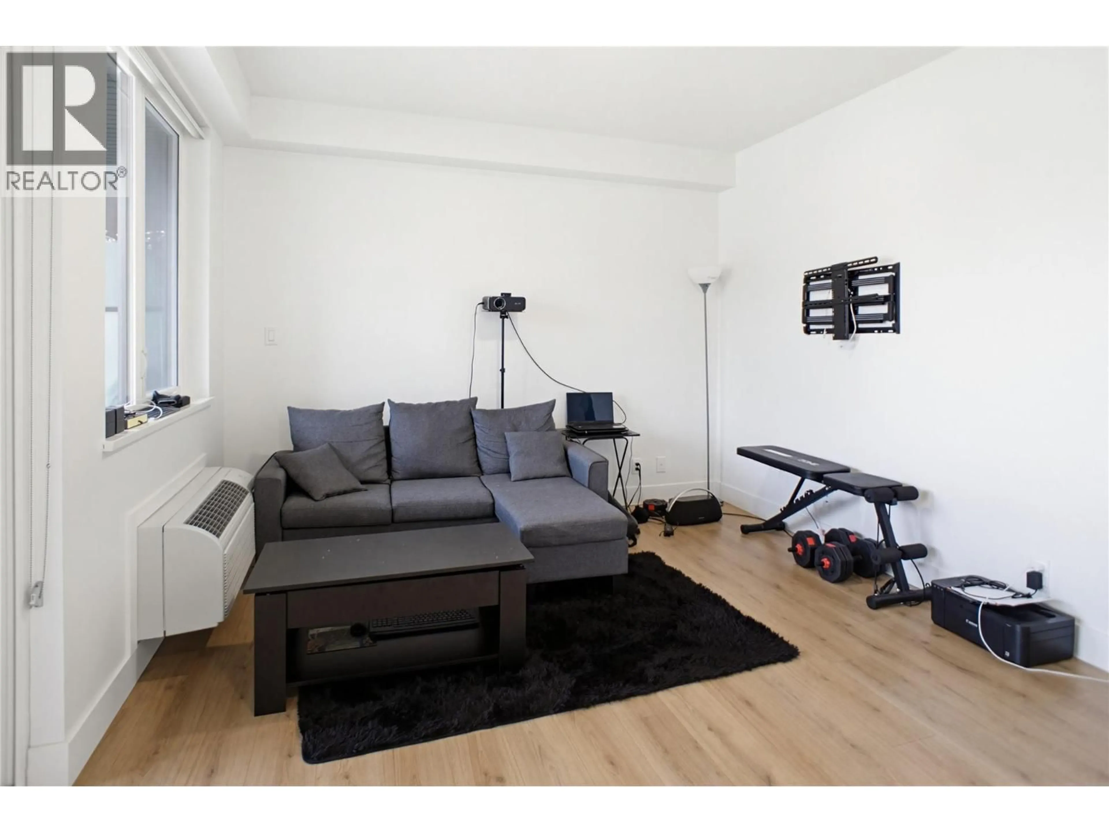 Living room with furniture, wood/laminate floor for 511 - 444 ST PAUL STREET, Kamloops British Columbia V2C0L2