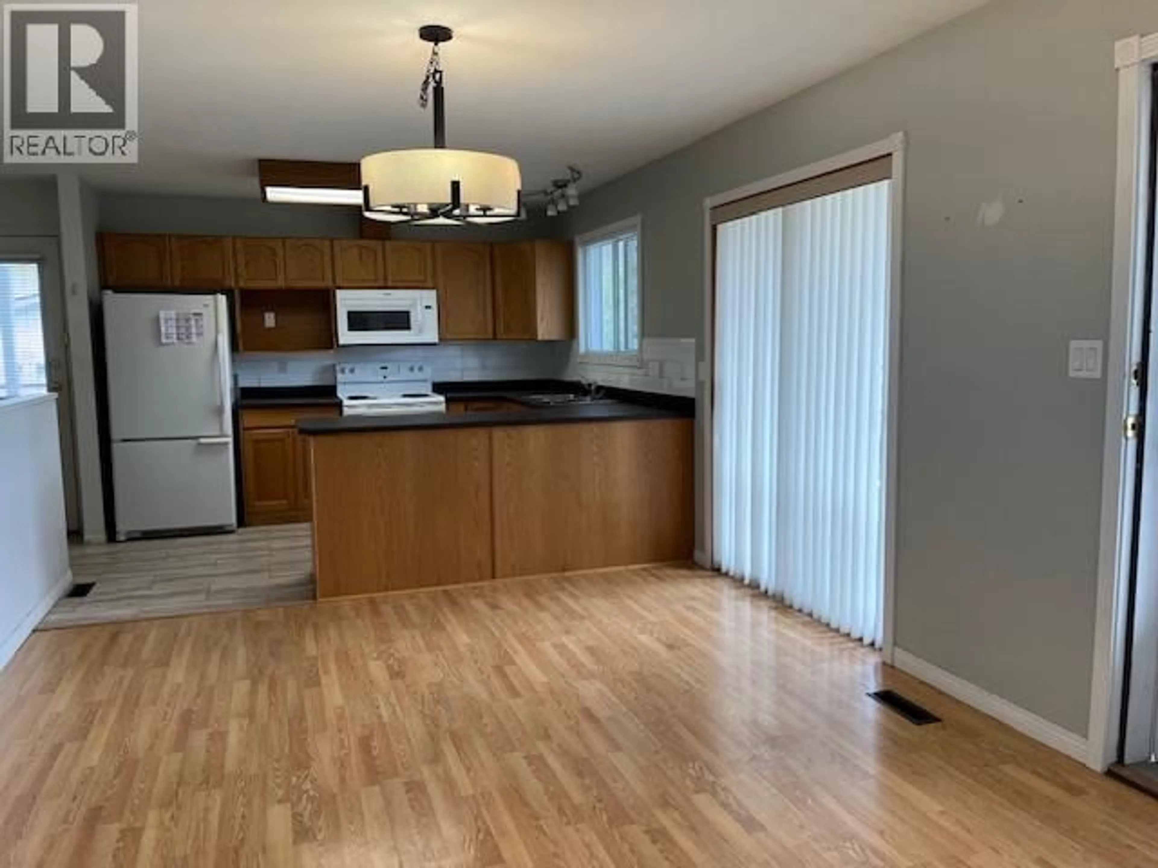 Open concept kitchen, wood/laminate floor for 4008 LOBELIA DRIVE, Osoyoos British Columbia V0H1V1