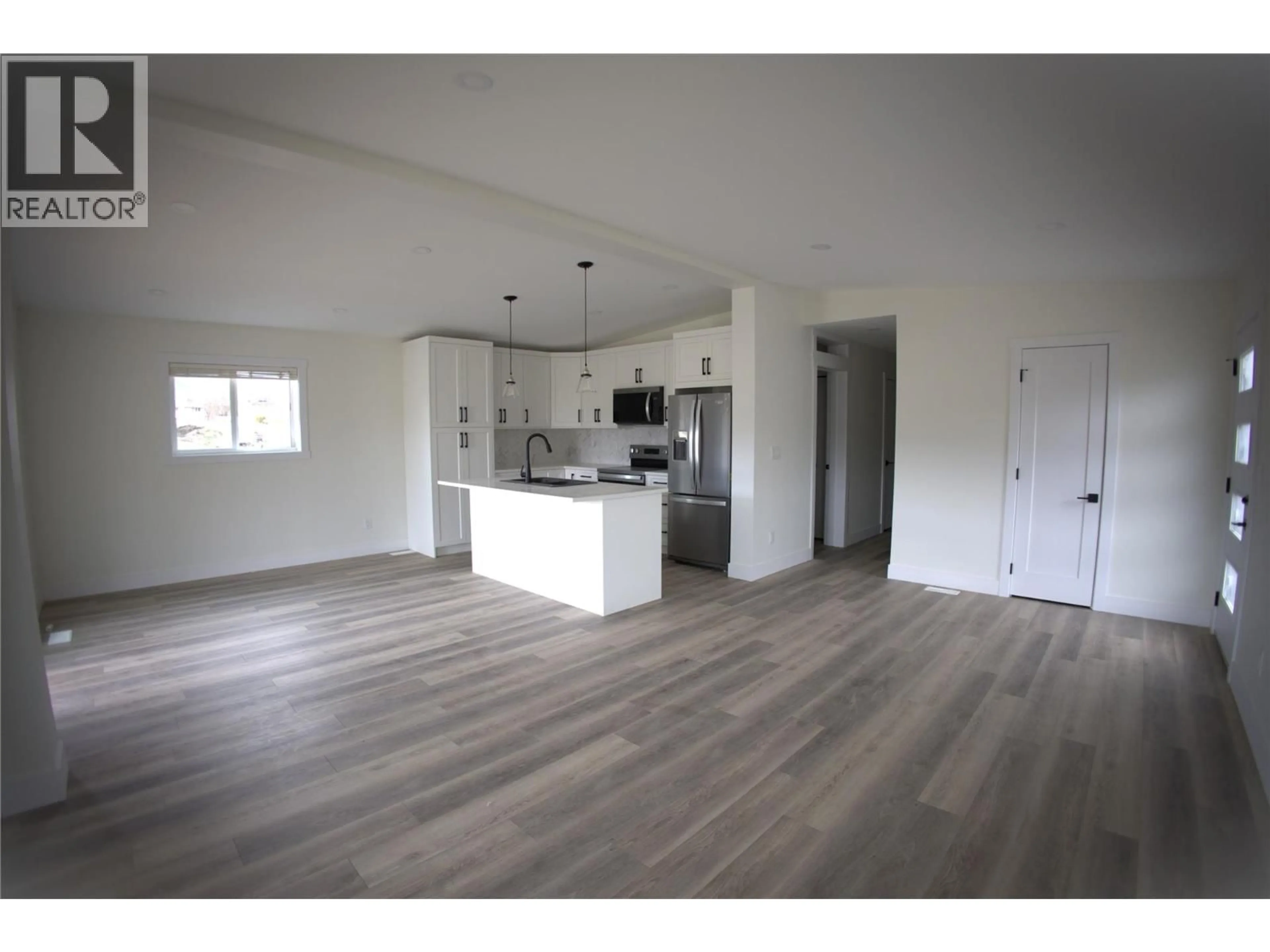 Open concept kitchen, wood/laminate floor for 6830 22ND STREET, Grand Forks British Columbia V0H1H0