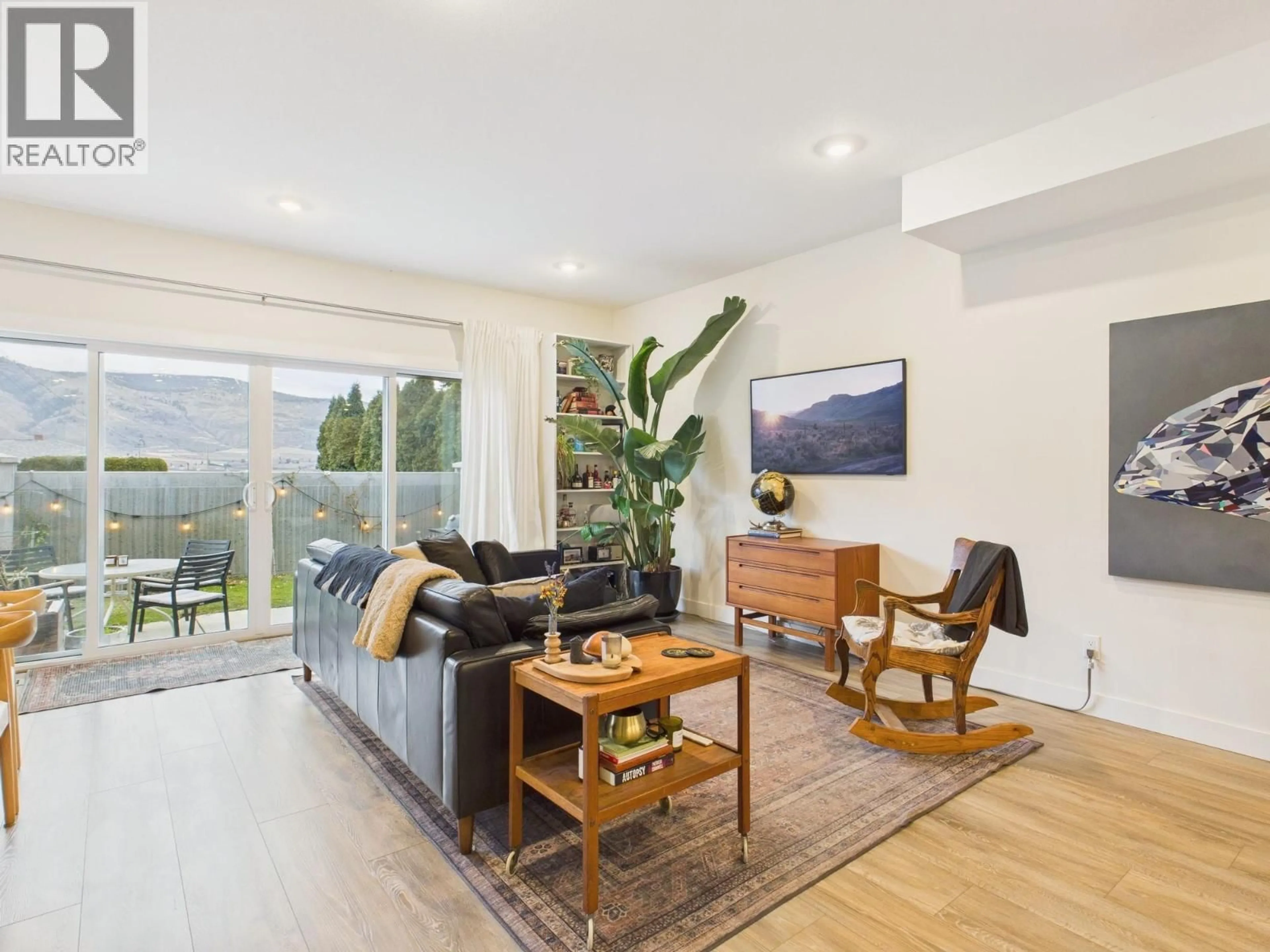 Living room with furniture, wood/laminate floor for 11 RAVEN COURT, Osoyoos British Columbia V0H1V5