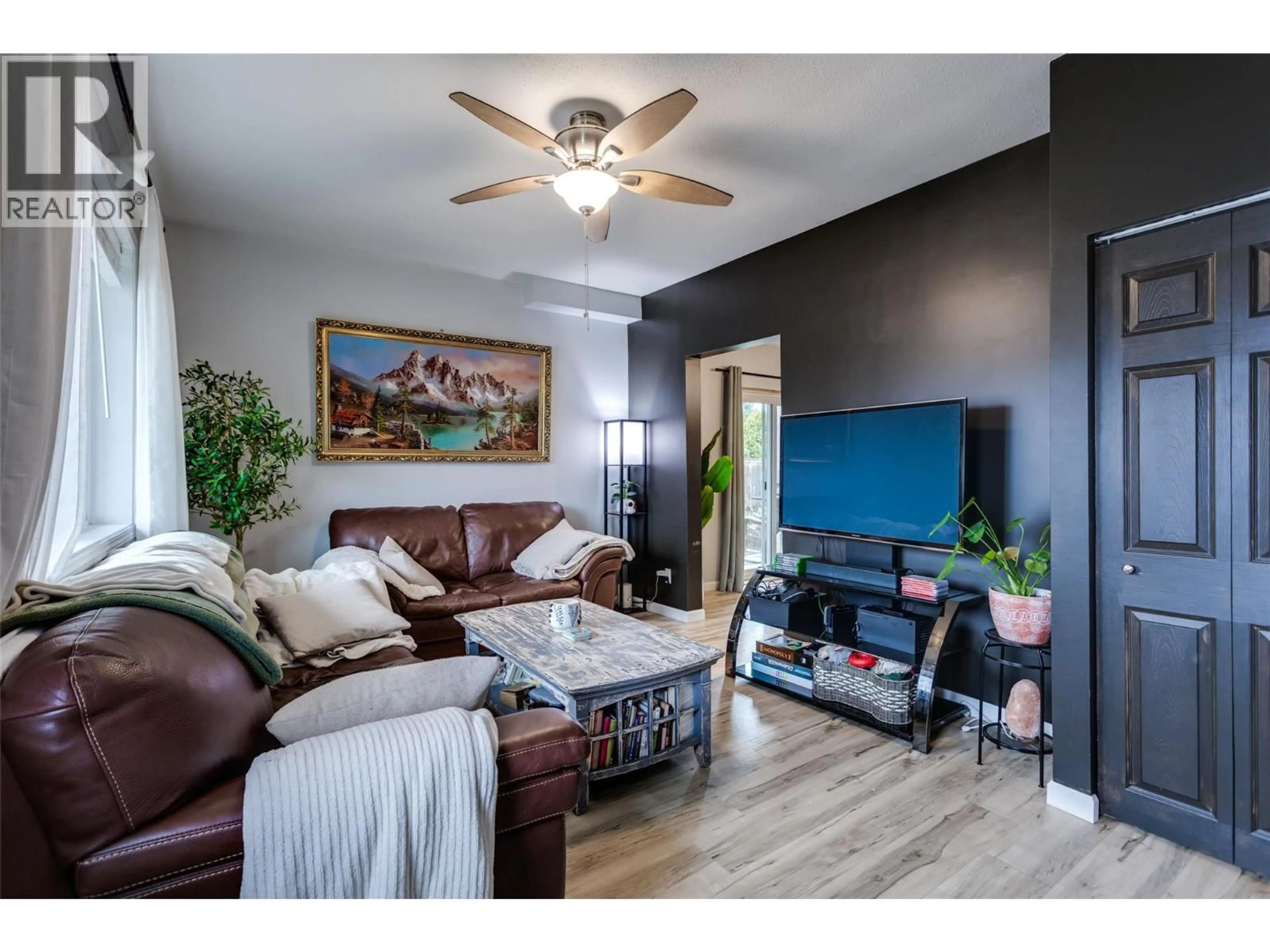 Living room with furniture, wood/laminate floor for 409 BAIRD AVENUE, Enderby British Columbia V4Y4A2