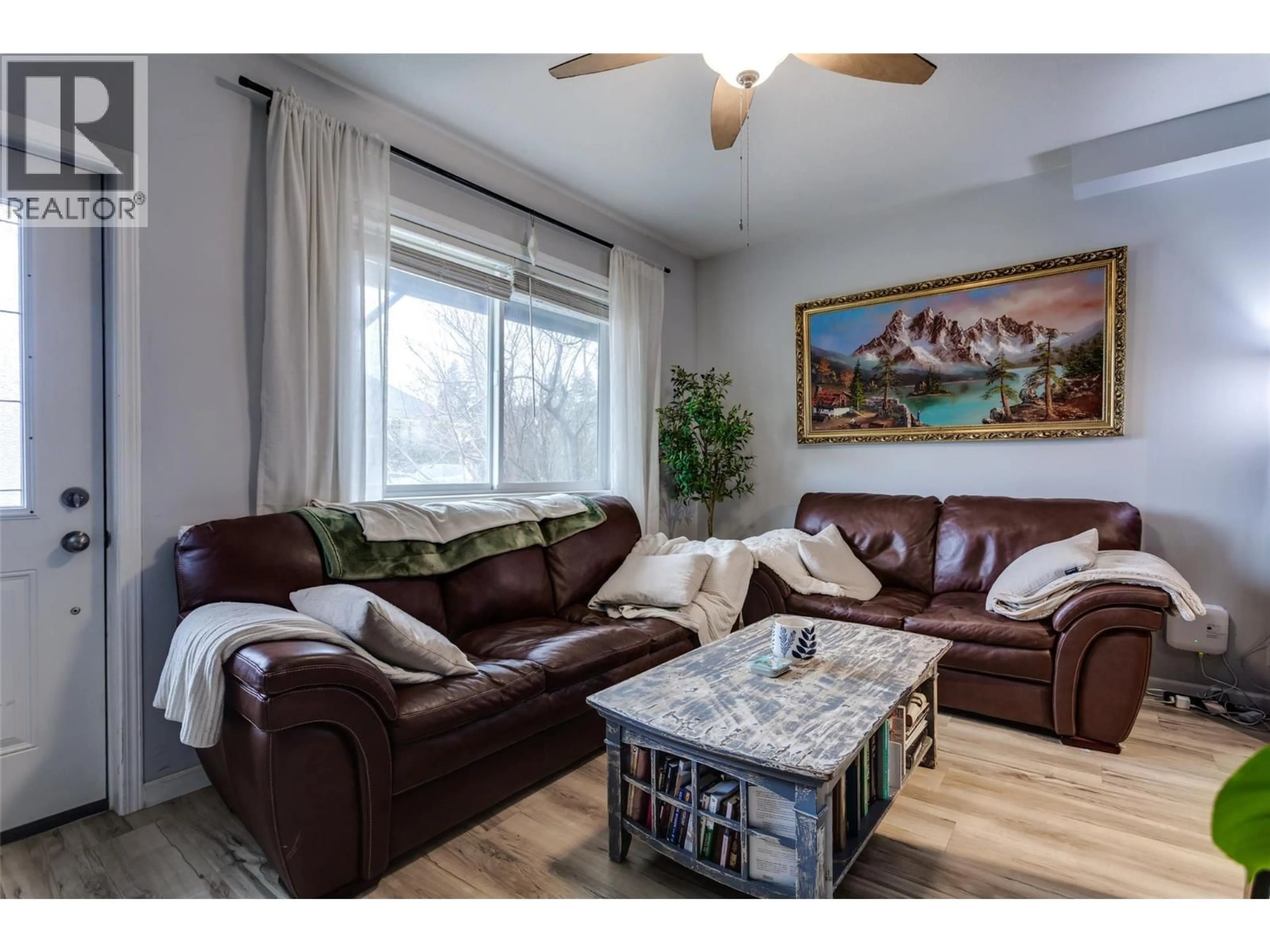 Living room with furniture, wood/laminate floor for 409 BAIRD AVENUE, Enderby British Columbia V4Y4A2