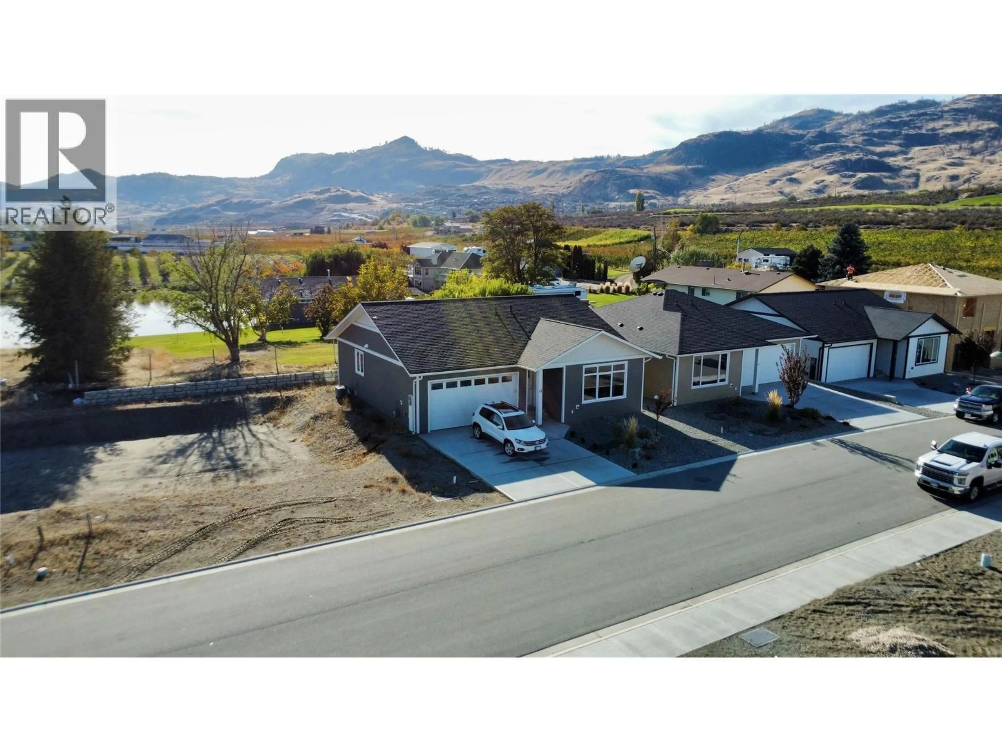 A pic from outside/outdoor area/front of a property/back of a property/a pic from drone, mountain view for 13 WOOD DUCK WAY, Osoyoos British Columbia V0H1V5