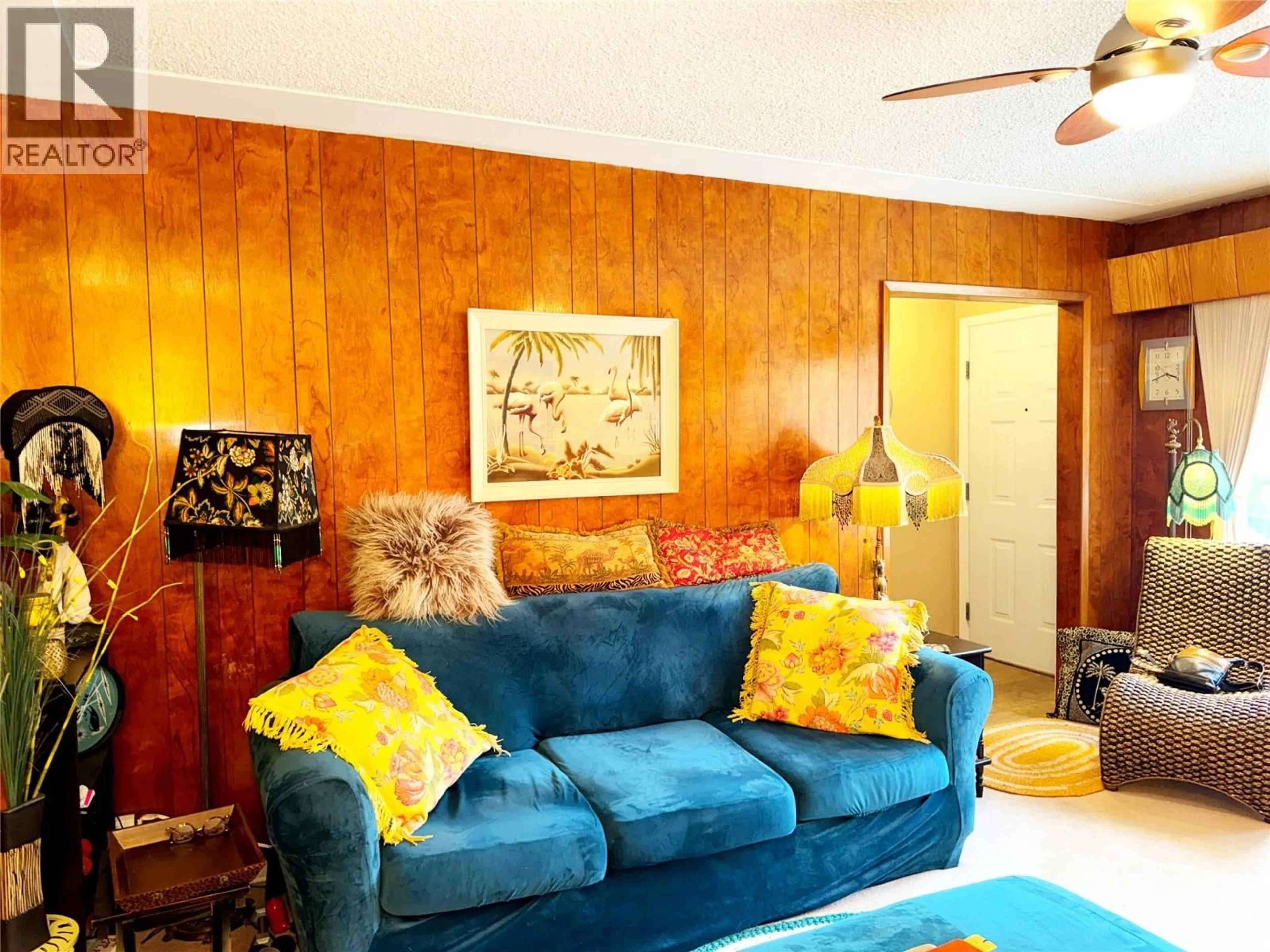 Living room with furniture, wood/laminate floor for 214 WELLINGTON AVENUE, Warfield British Columbia V1R2K5
