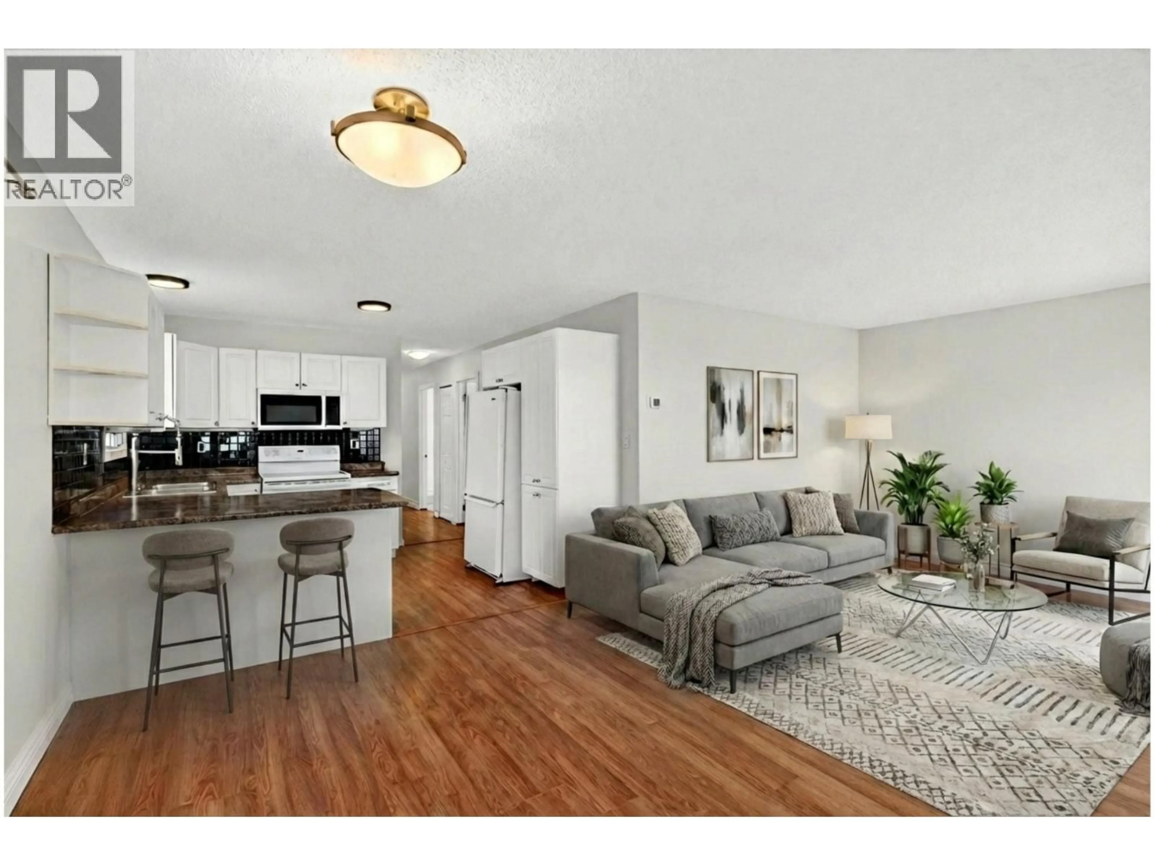 Living room with furniture, wood/laminate floor for 1031 MARTIN AVENUE, Kelowna British Columbia V1Y6V6