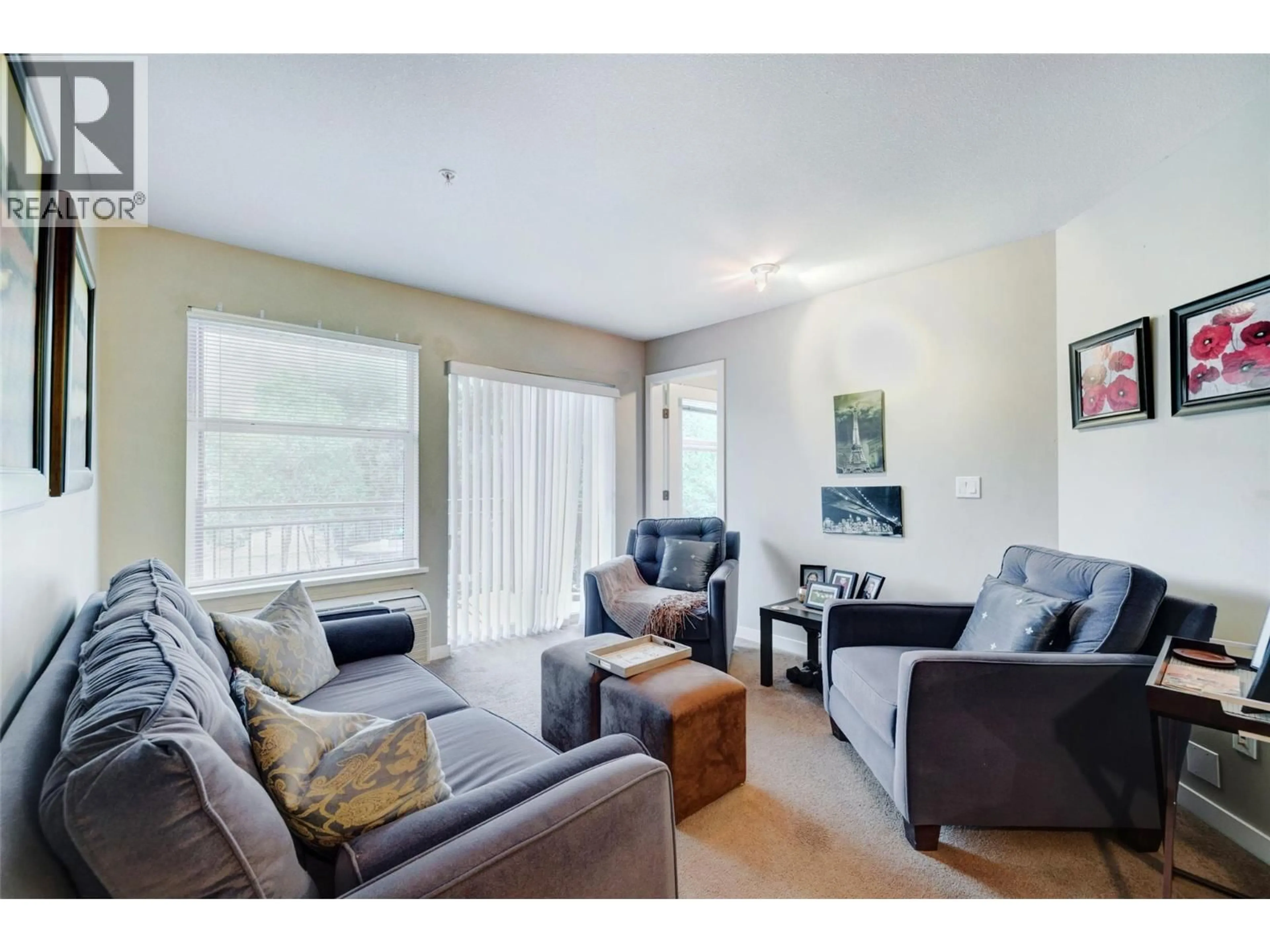 Living room with furniture, wood/laminate floor for 312 - 555 YATES ROAD, Kelowna British Columbia V1V2V2