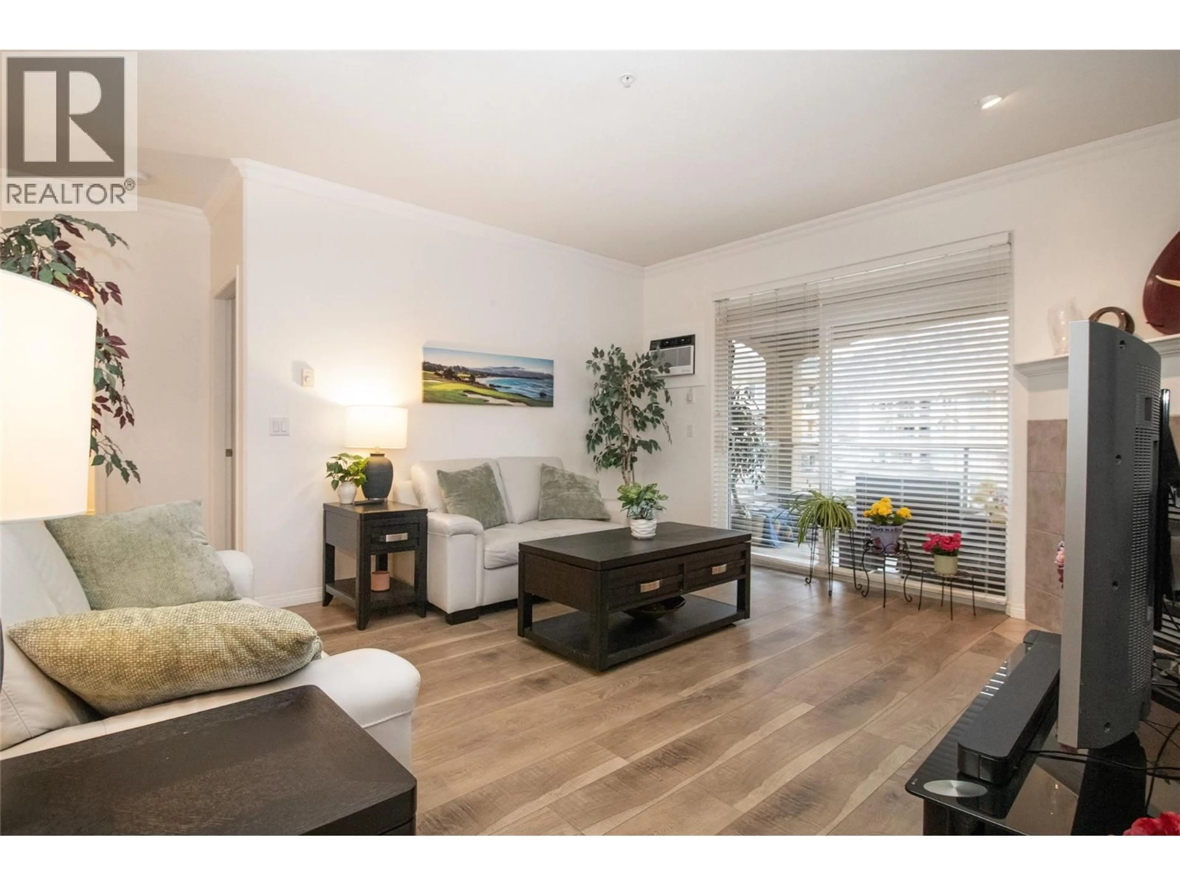 Living room with furniture, wood/laminate floor for 309 - 1960 ENTERPRISE WAY, Kelowna British Columbia V1Y9S5