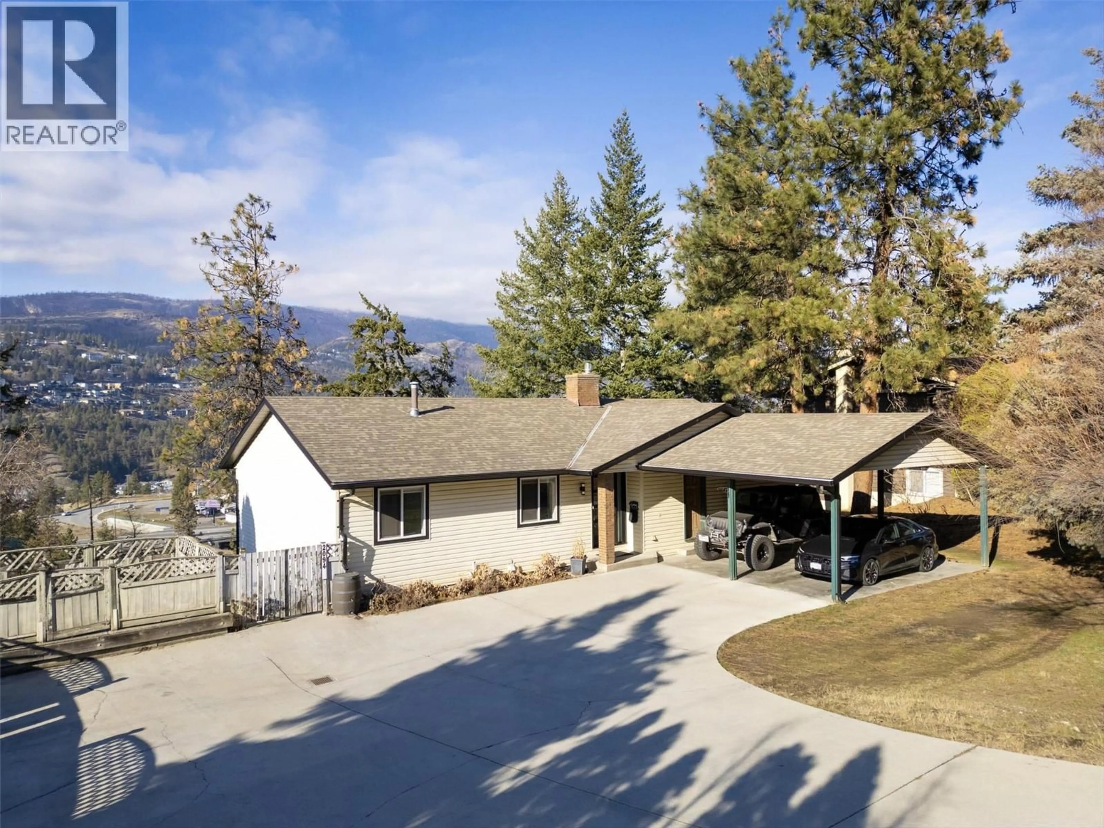 A pic from outside/outdoor area/front of a property/back of a property/a pic from drone, mountain view for 2094 TOMAT AVENUE, Kelowna British Columbia V1Z3J2