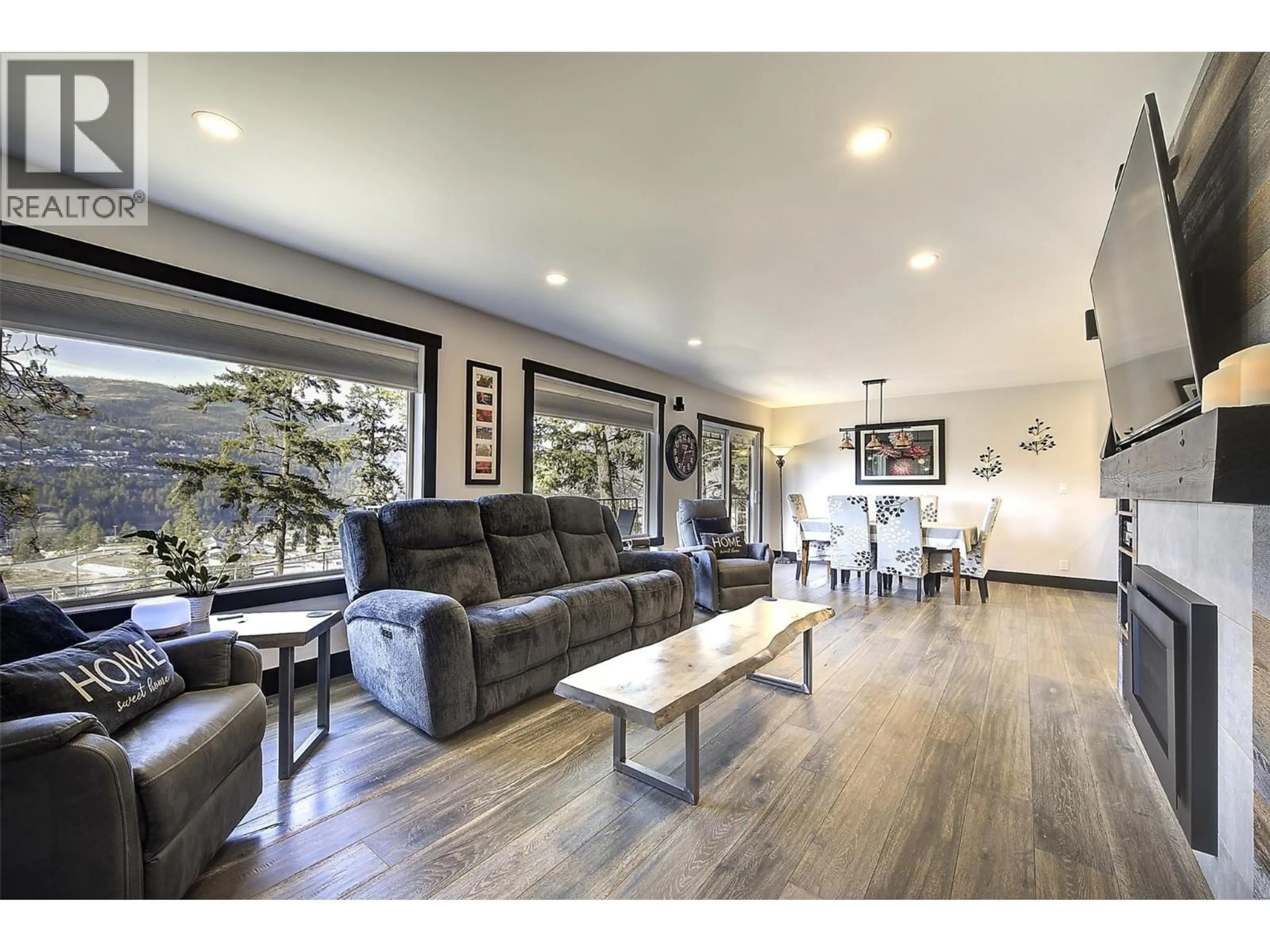 Living room with furniture, wood/laminate floor for 2094 TOMAT AVENUE, Kelowna British Columbia V1Z3J2