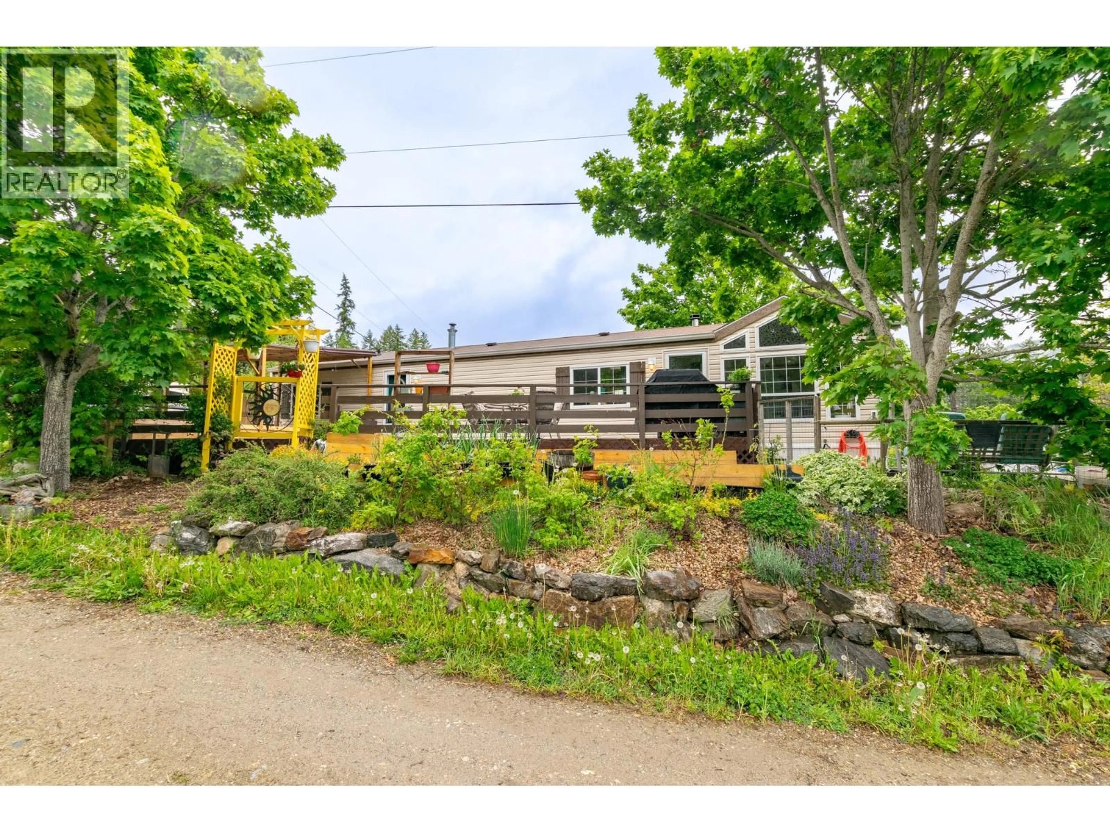 A pic from outside/outdoor area/front of a property/back of a property/a pic from drone, street for 12 - 6696 SUNNYBRAE CANOE POINT ROAD, Tappen British Columbia V0E2X1