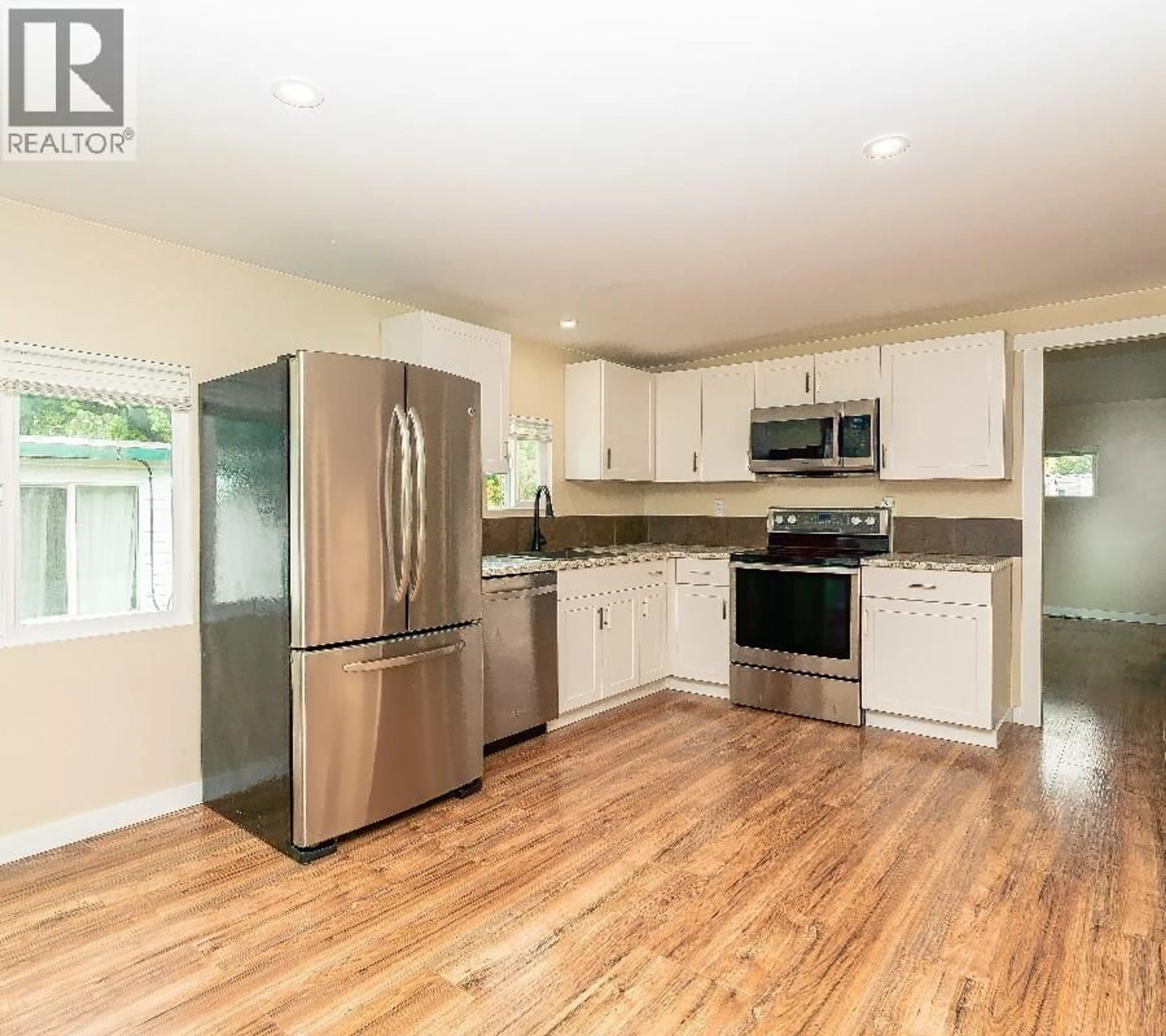 Open concept kitchen, wood/laminate floor for 2065 BOUCHERIE ROAD, West Kelowna British Columbia V4T2A8