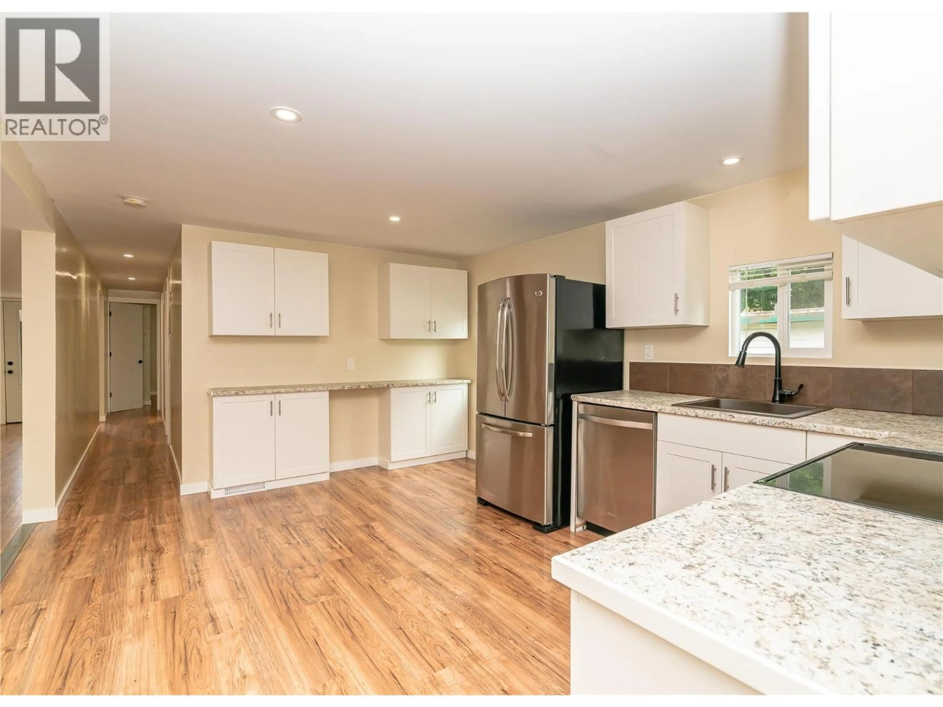 Open concept kitchen, wood/laminate floor for 2065 BOUCHERIE ROAD, West Kelowna British Columbia V4T2A8