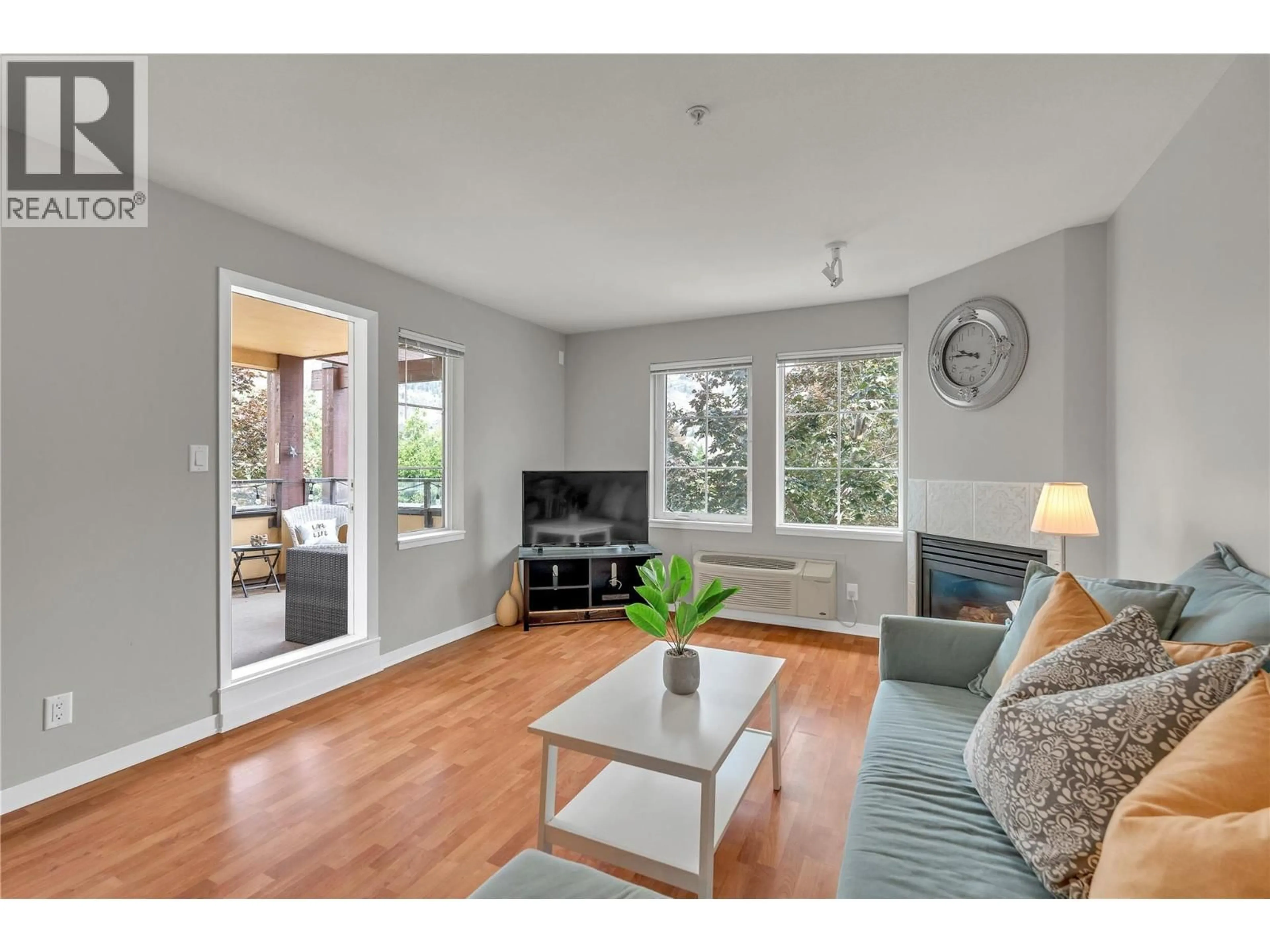 Living room with furniture, wood/laminate floor for 202 - 7600 COTTONWOOD DRIVE, Osoyoos British Columbia V0H1V3