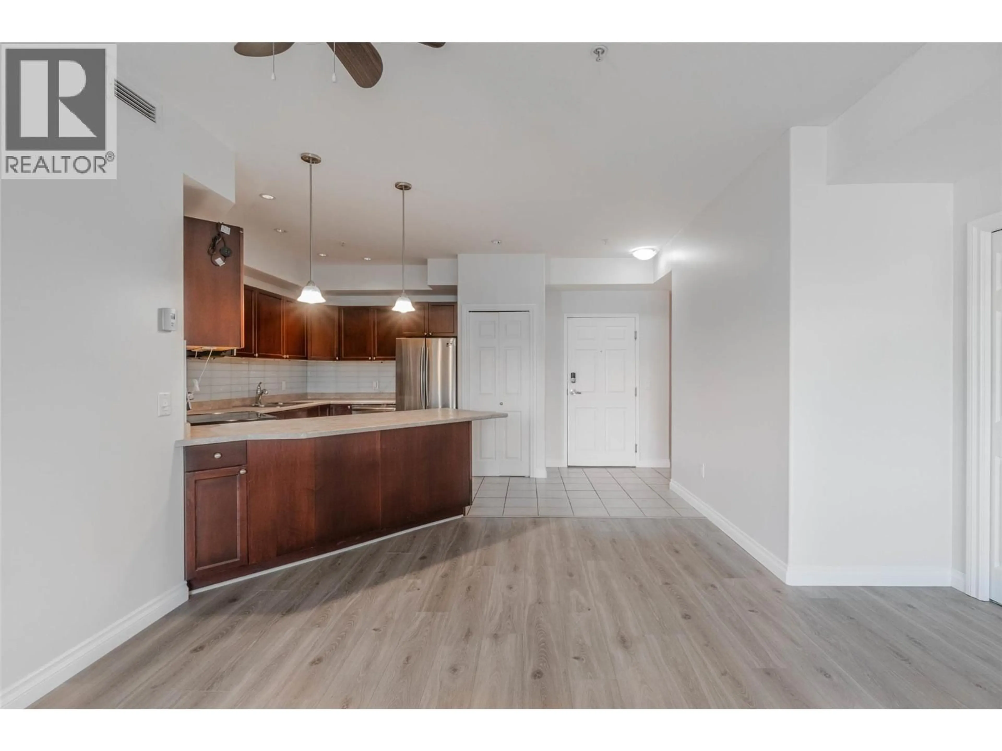 Open concept kitchen, wood/laminate floor for 212C - 921 SPILLWAY ROAD, Oliver British Columbia V0H1T8