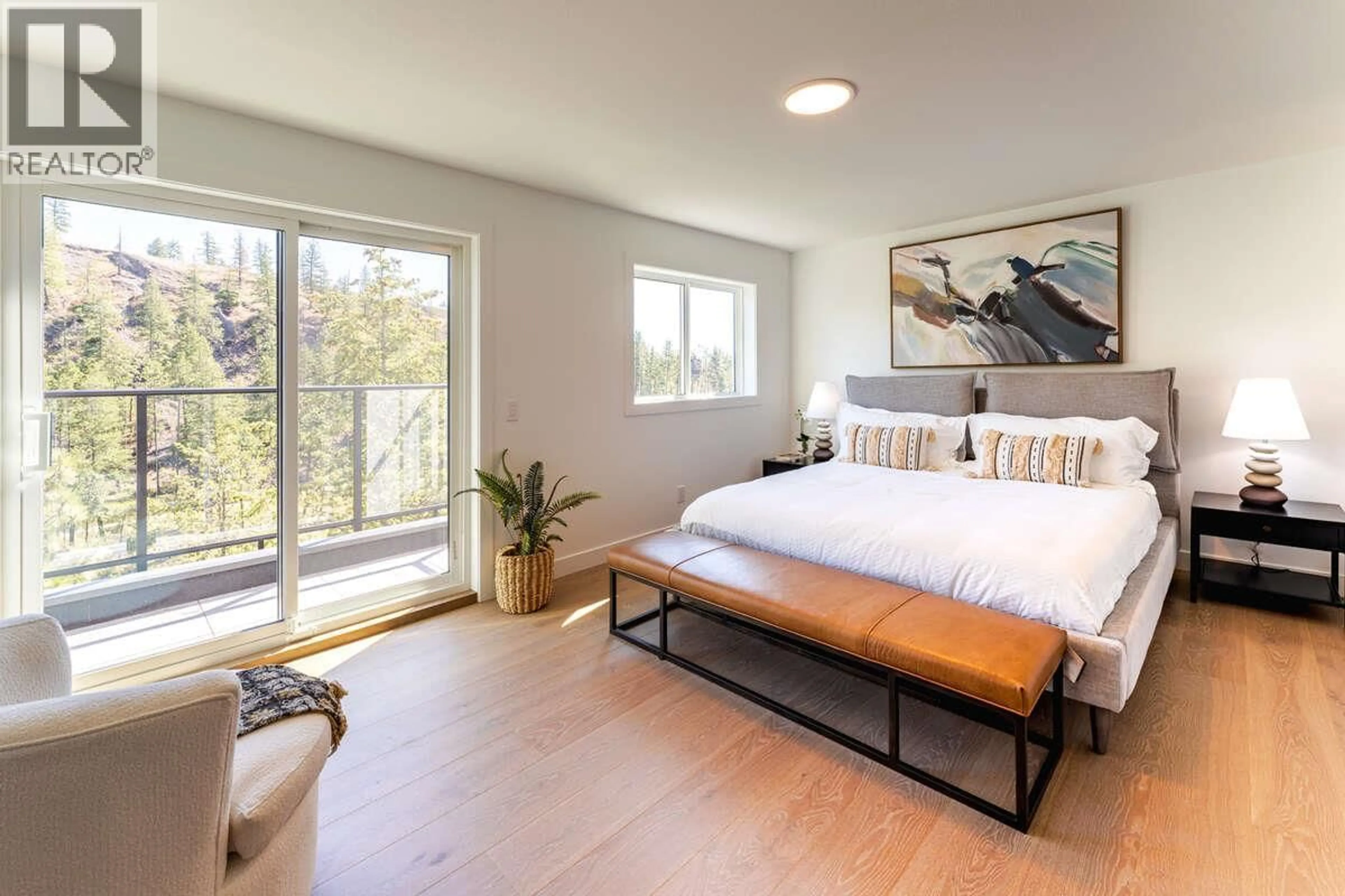 Bedroom with bed, wood/laminate floor for 56 - 1550 UNION ROAD, Kelowna British Columbia V1V2W4