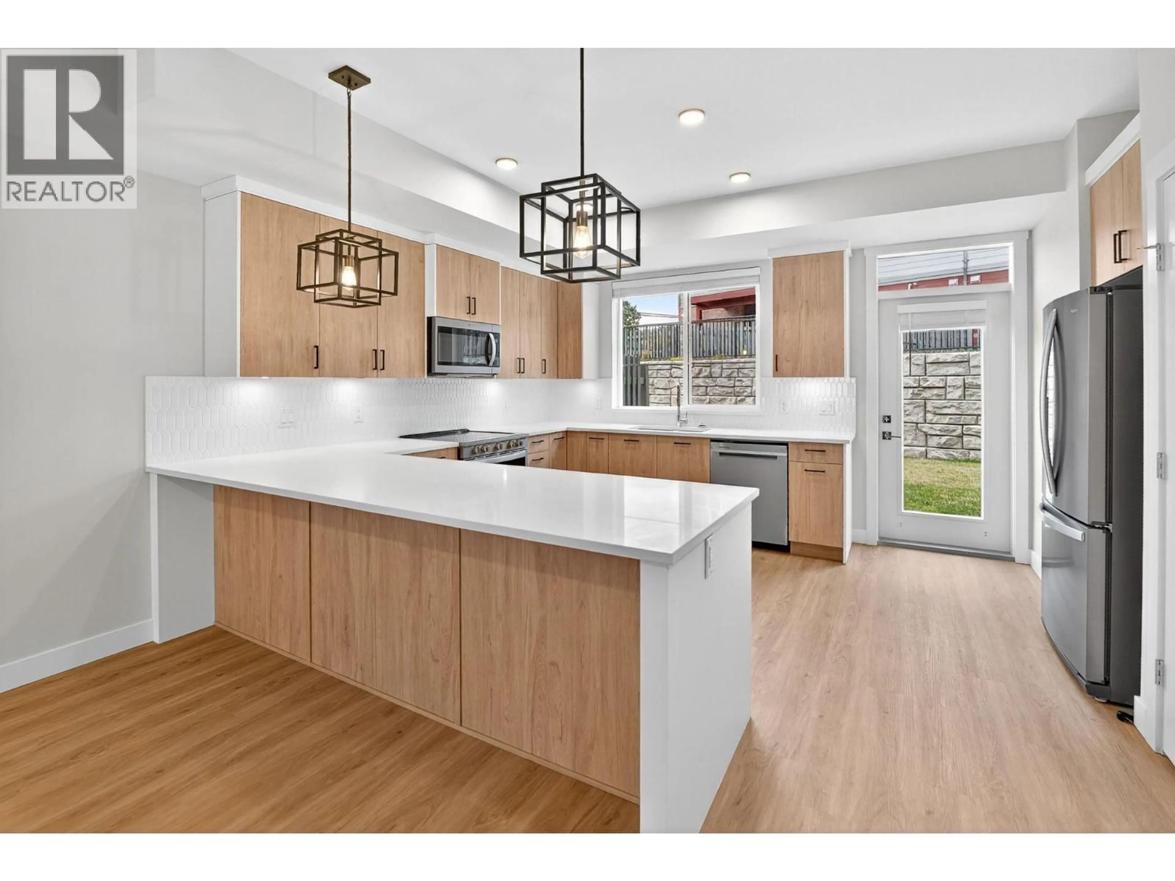 Open concept kitchen, wood/laminate floor for 190 - 4025 GELLATLY ROAD SOUTH, West Kelowna British Columbia V4T0E6