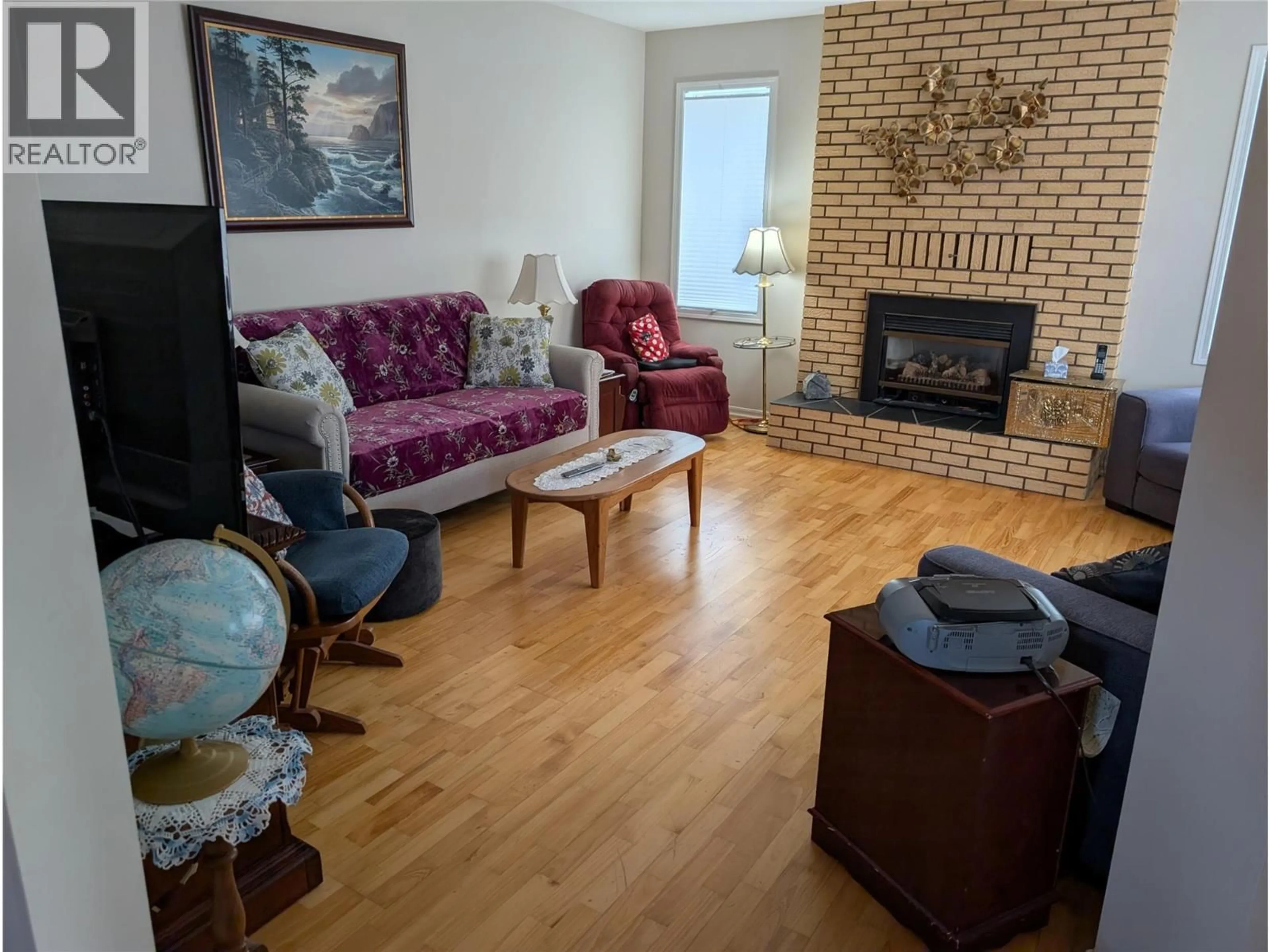 Living room with furniture, wood/laminate floor for 215 GREENWOOD DRIVE, Penticton British Columbia V2A7P9