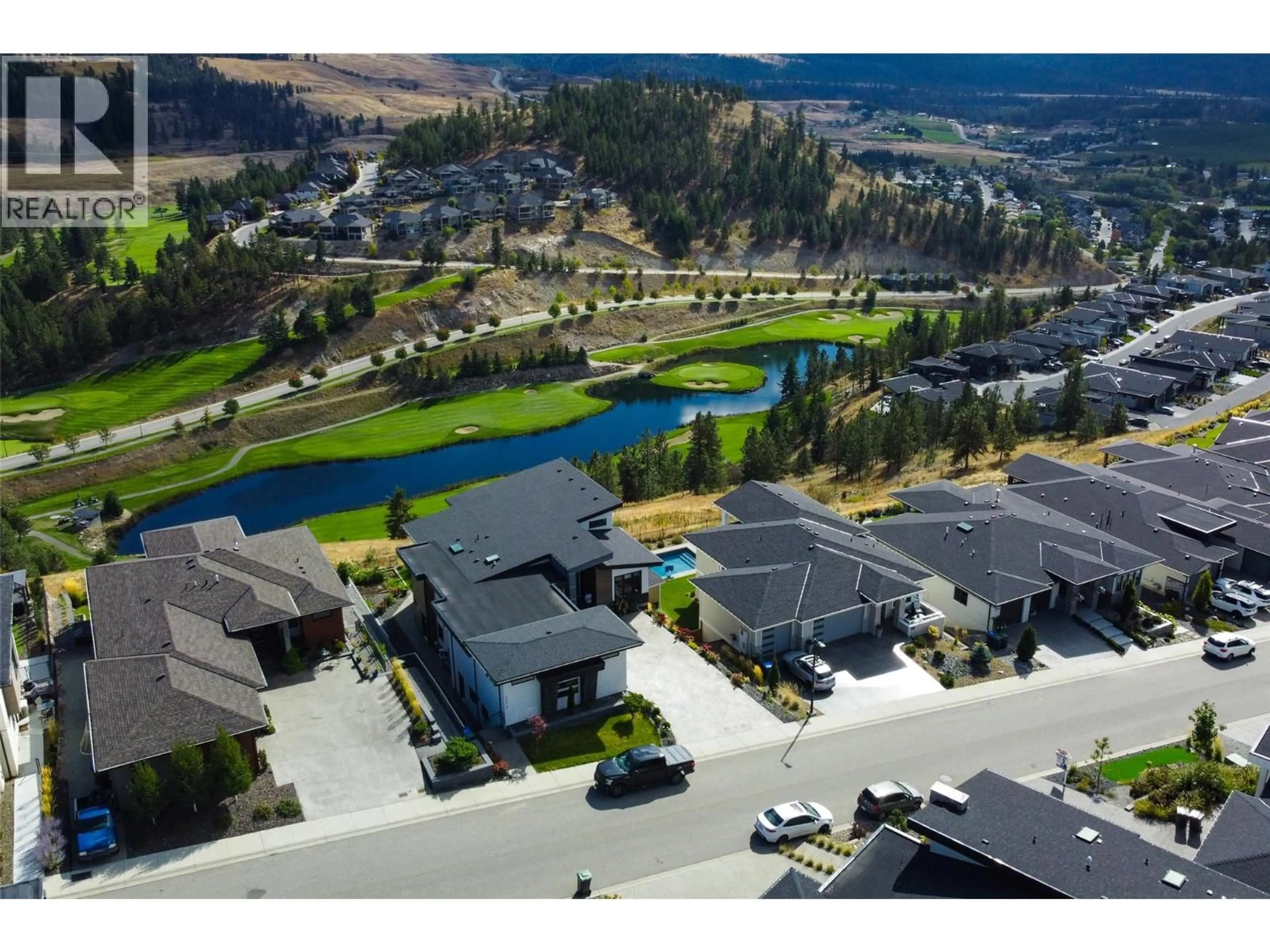 A pic from outside/outdoor area/front of a property/back of a property/a pic from drone, mountain view for 703 CARNOUSTIE DRIVE, Kelowna British Columbia V1P1V2