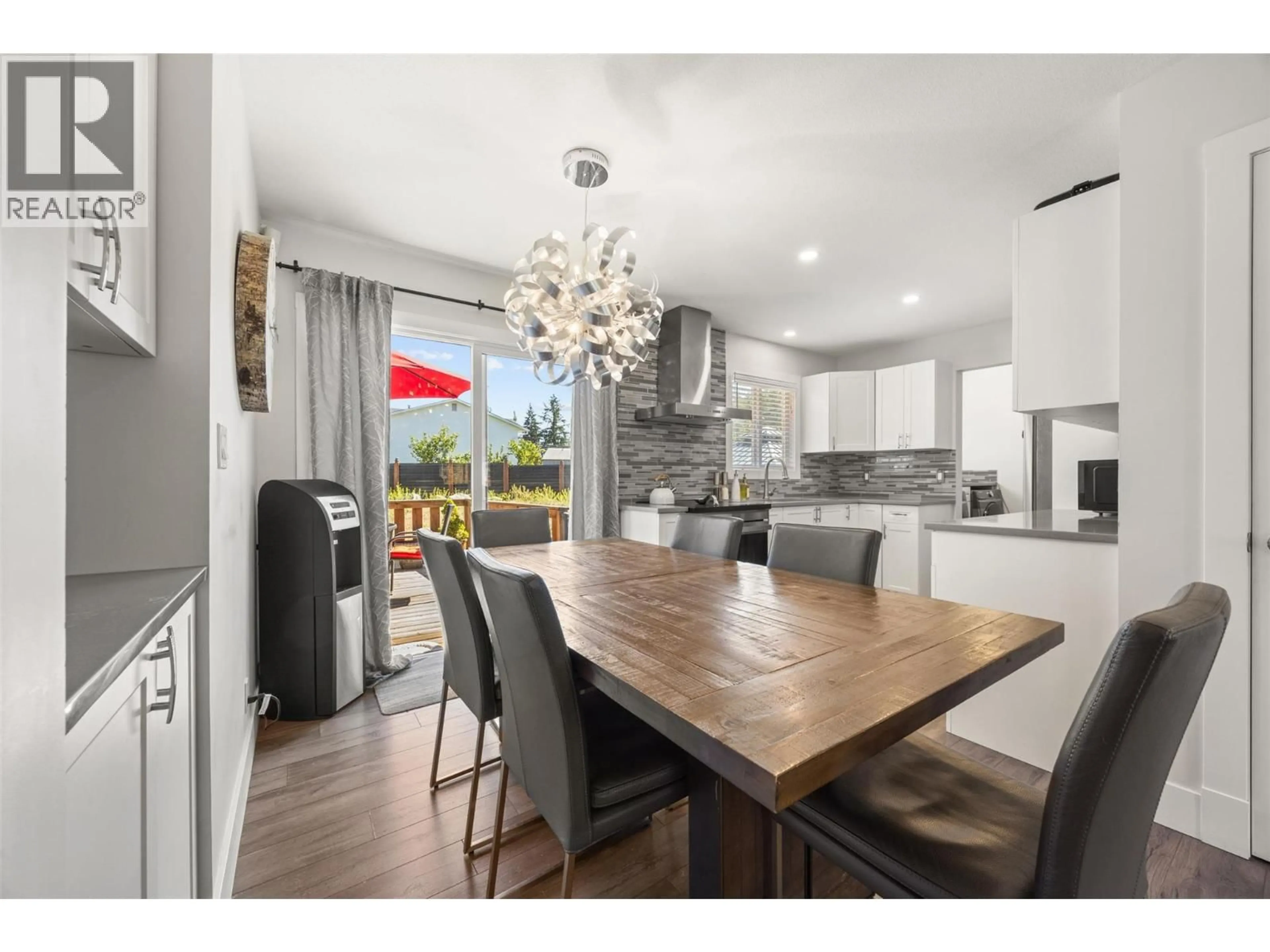 Open concept kitchen, wood/laminate floor for 1255 RIO DRIVE, Kelowna British Columbia V1V1E2