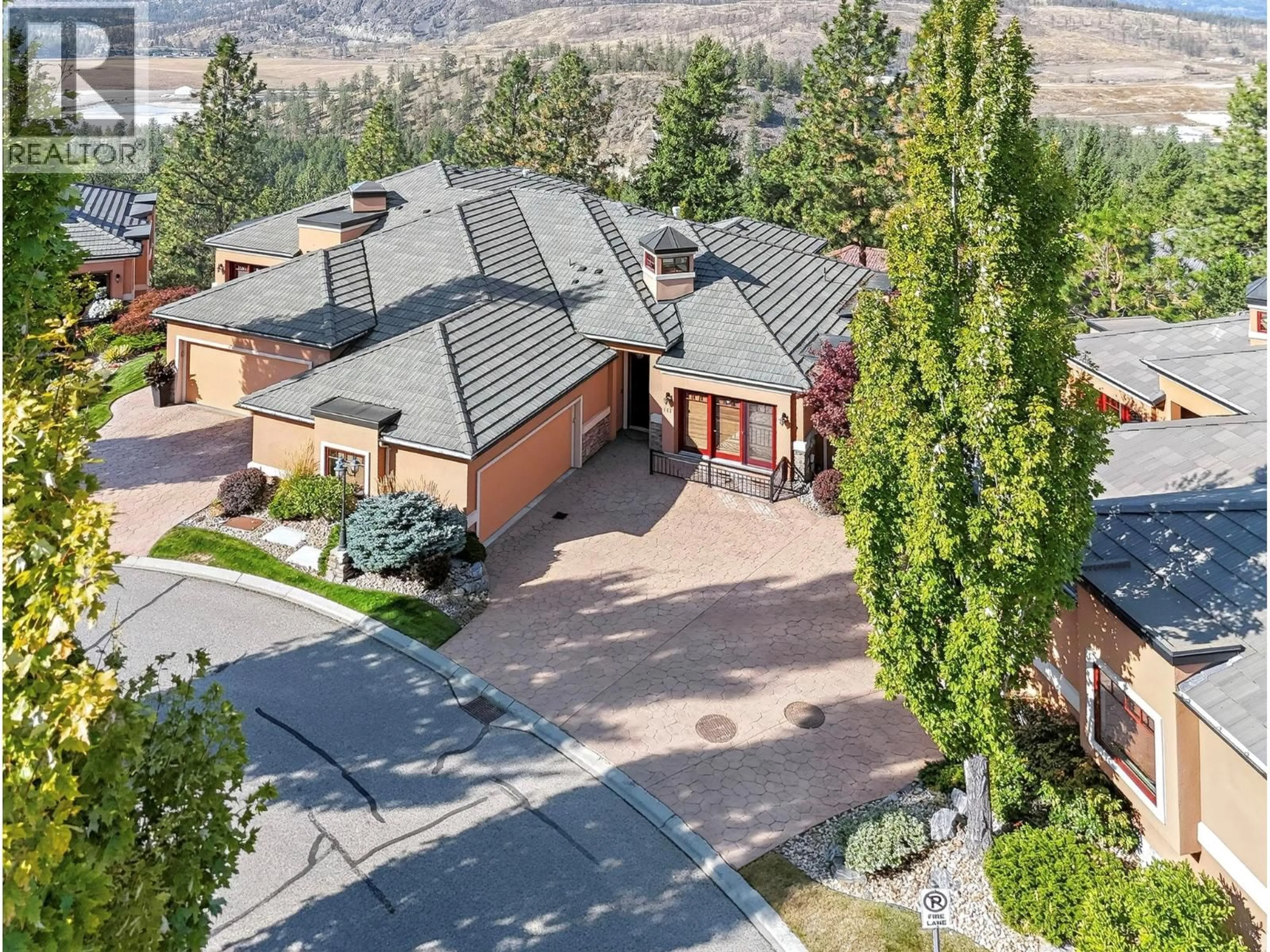 A pic from outside/outdoor area/front of a property/back of a property/a pic from drone, mountain view for 111 - 1910 CAPISTRANO DRIVE, Kelowna British Columbia V1V2S5
