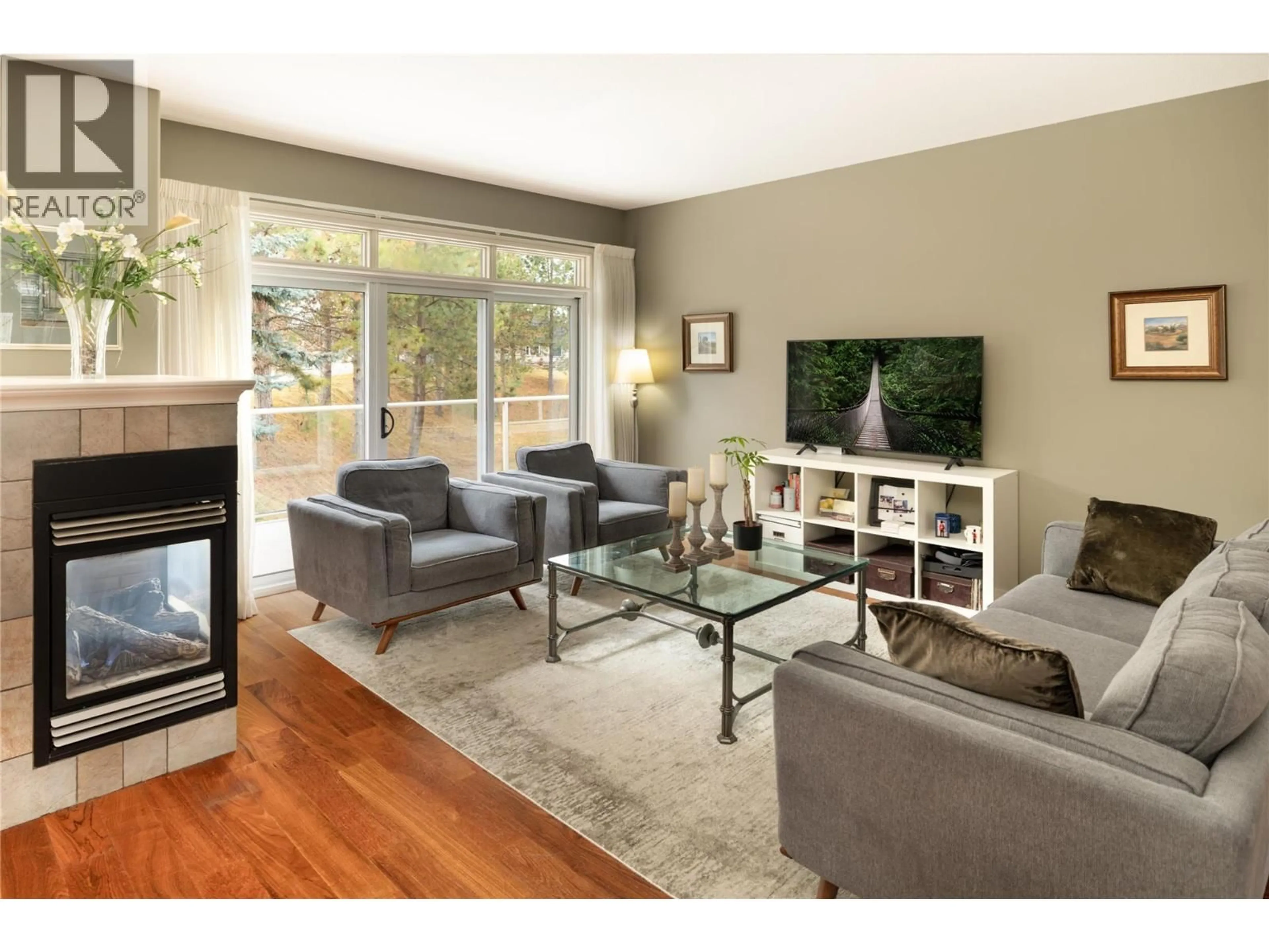 Living room with furniture, wood/laminate floor for 4182 GALLAGHERS BOULEVARD SOUTH, Kelowna British Columbia V1V4X2