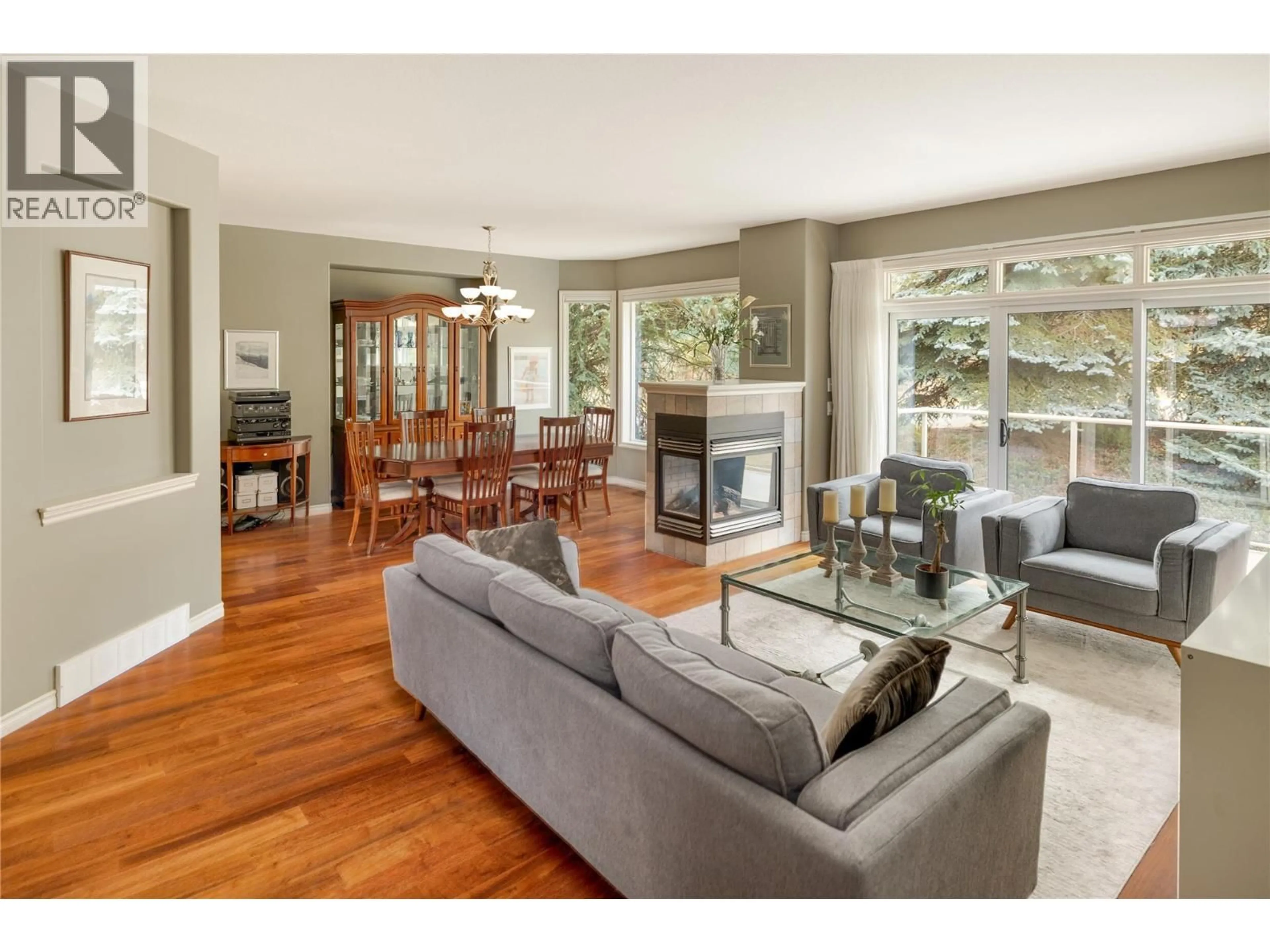 Living room with furniture, wood/laminate floor for 4182 GALLAGHERS BOULEVARD SOUTH, Kelowna British Columbia V1V4X2