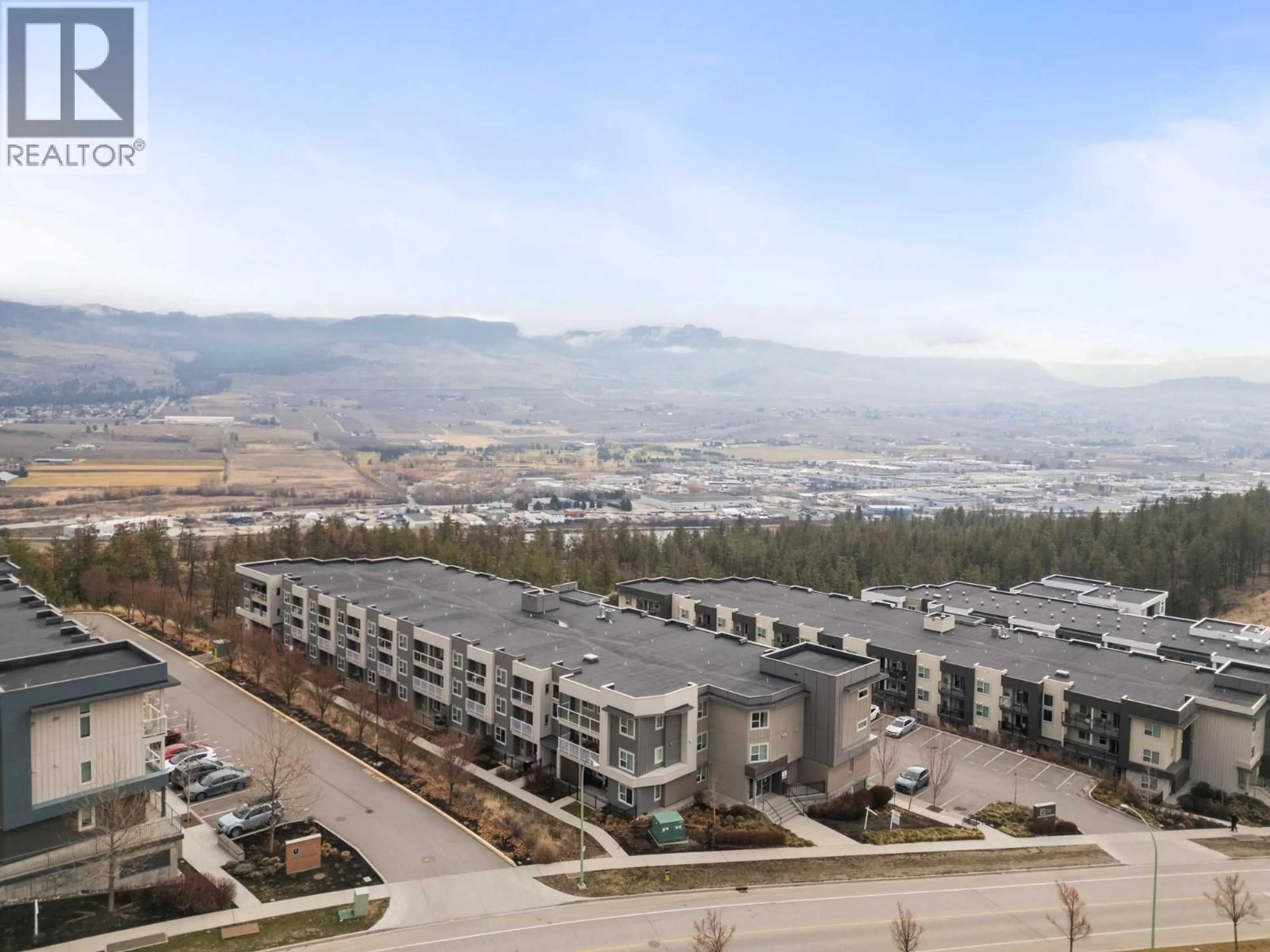 A pic from outside/outdoor area/front of a property/back of a property/a pic from drone, mountain view for 122 - 695 ACADEMY WAY, Kelowna British Columbia V1V0C7