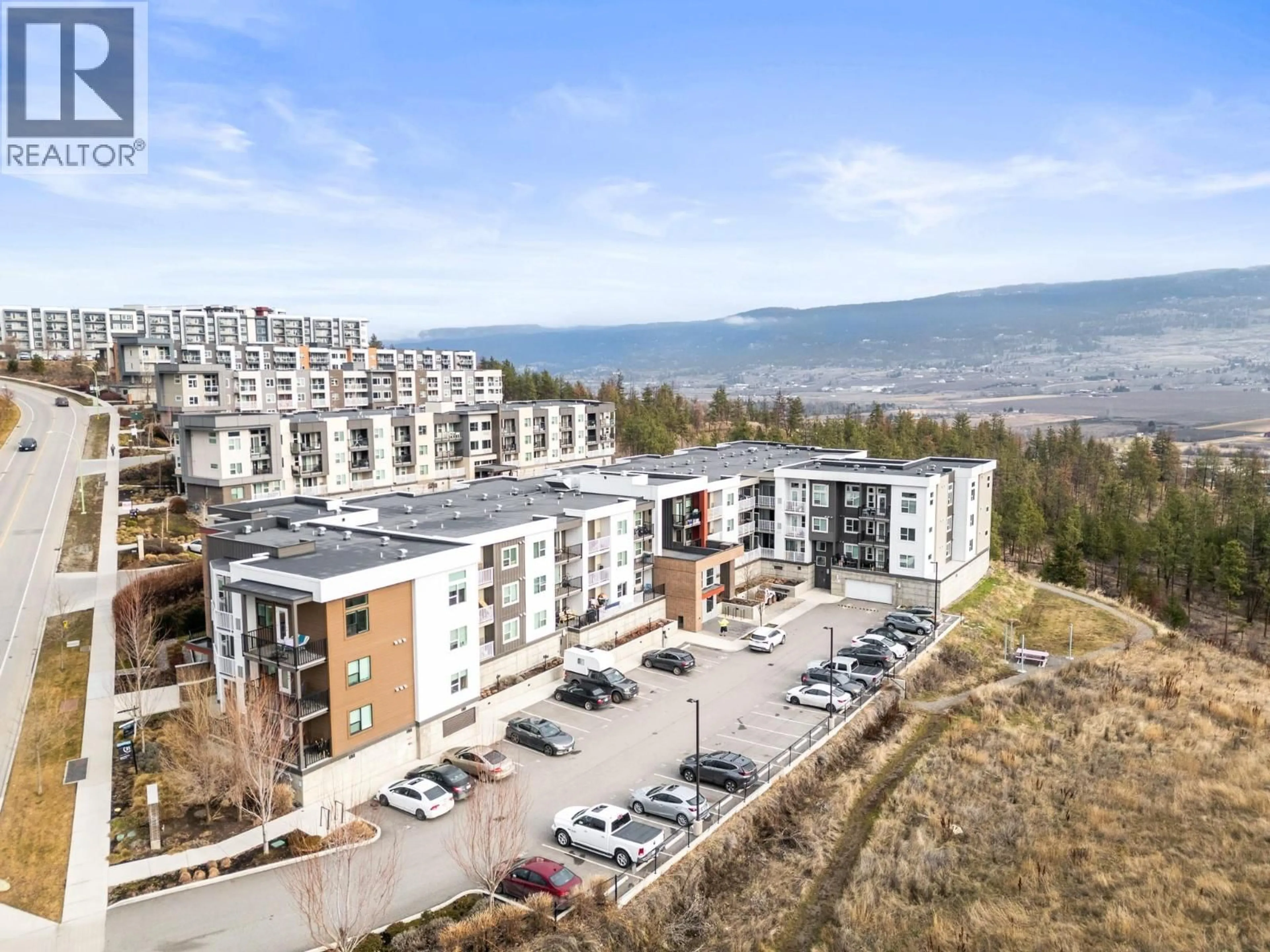 A pic from outside/outdoor area/front of a property/back of a property/a pic from drone, mountain view for PH25 - 625 ACADEMY WAY, Kelowna British Columbia V1V0E3
