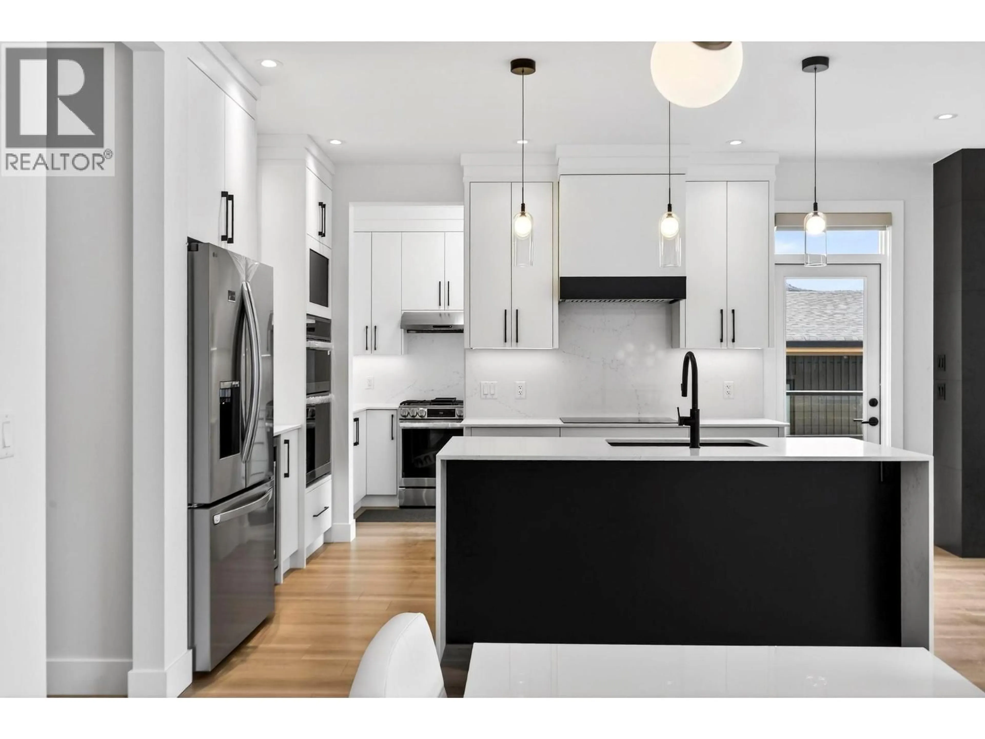 Contemporary kitchen, wood/laminate floor for 10-1960 NORTHERN FLICKER COURT, Kelowna British Columbia V1V0G3