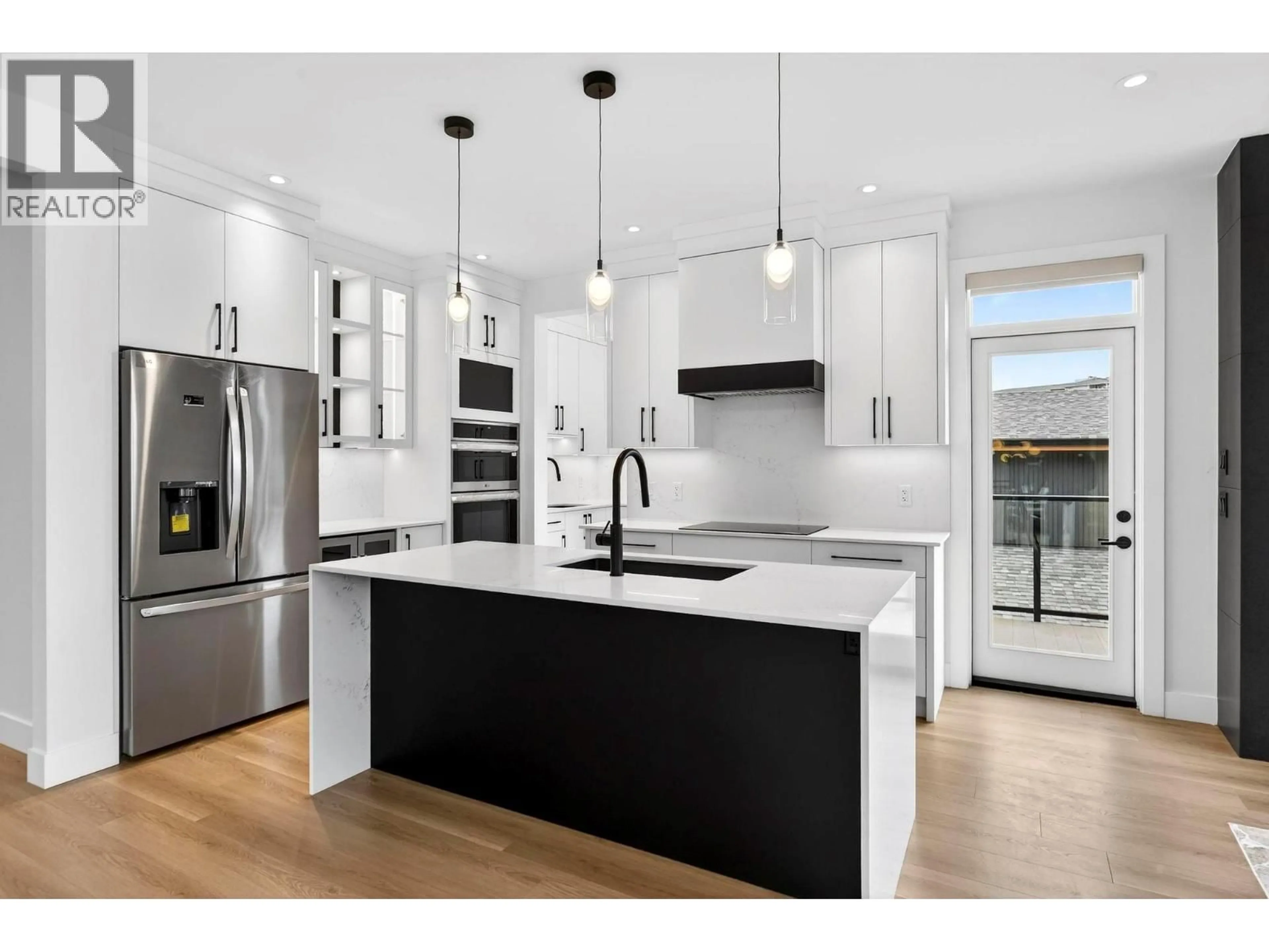 Open concept kitchen, wood/laminate floor for 10-1960 NORTHERN FLICKER COURT, Kelowna British Columbia V1V0G3