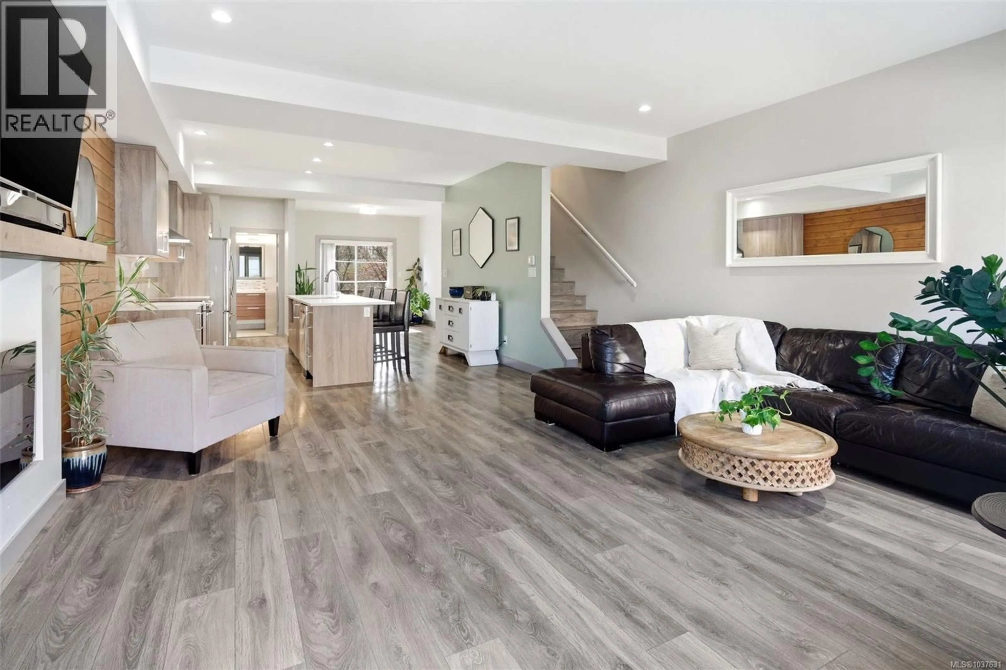 Living room with furniture, wood/laminate floor for 103 - 687 STRANDLUND AVENUE, Langford British Columbia V9B3G2