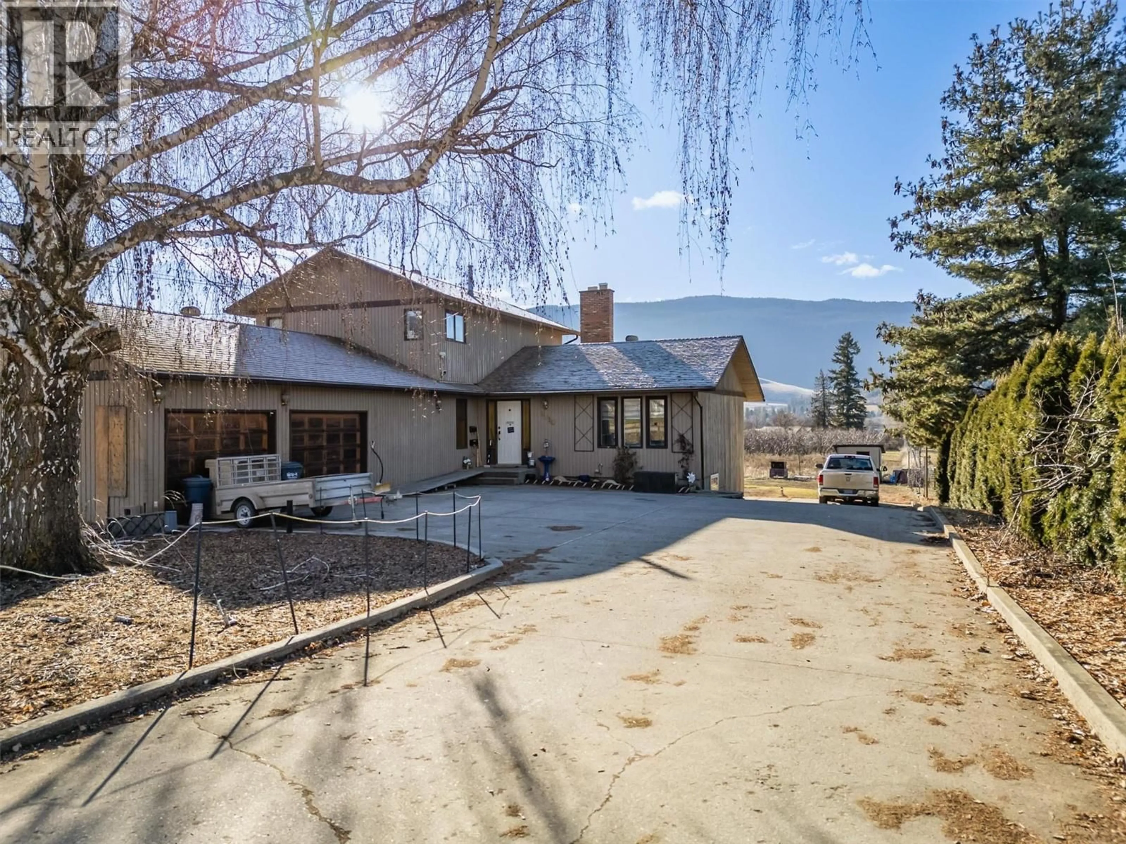 A pic from outside/outdoor area/front of a property/back of a property/a pic from drone, mountain view for 9810 VENABLES DRIVE, Coldstream British Columbia V1B2J9