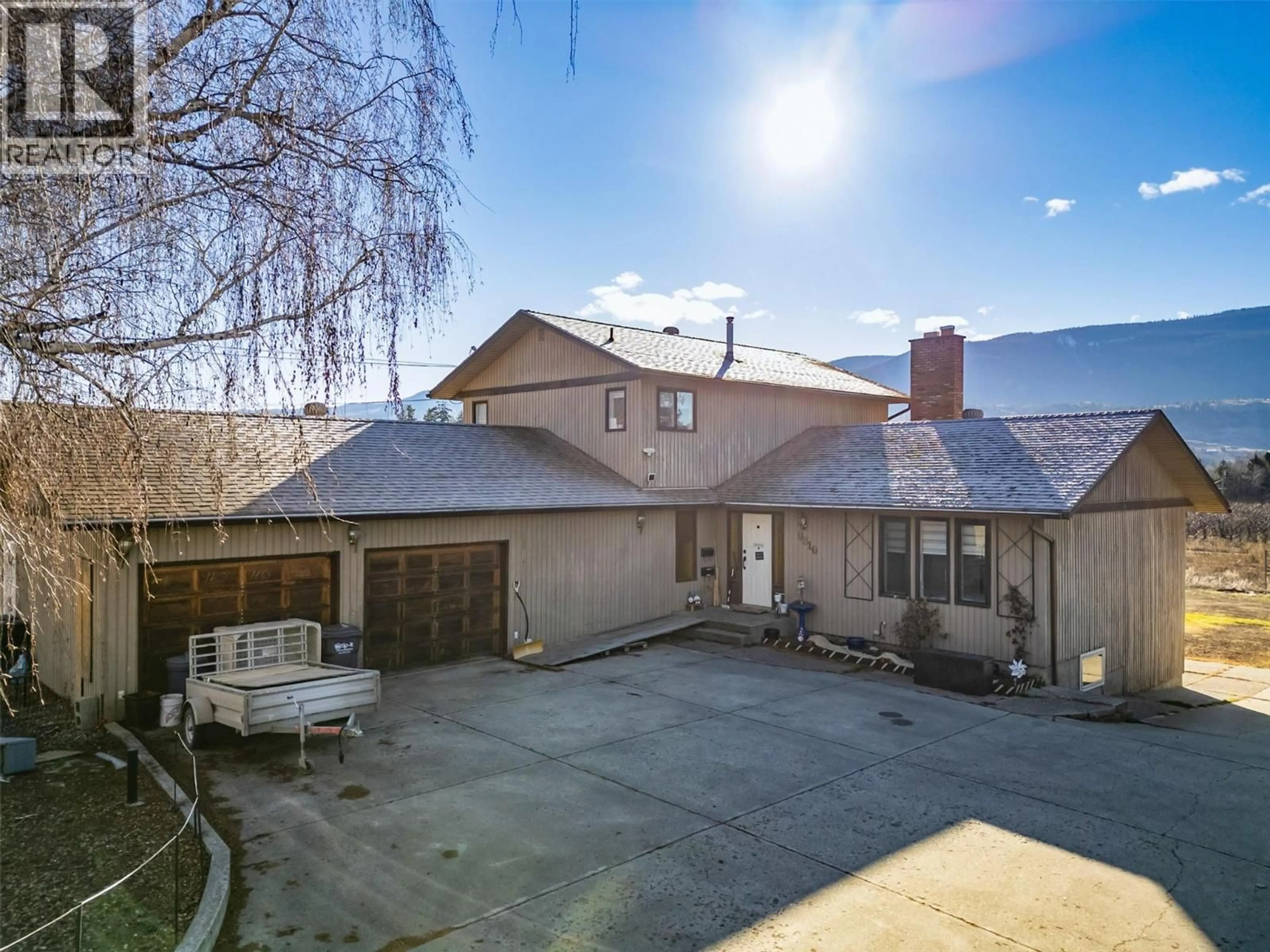 A pic from outside/outdoor area/front of a property/back of a property/a pic from drone, mountain view for 9810 VENABLES DRIVE, Coldstream British Columbia V1B2J9