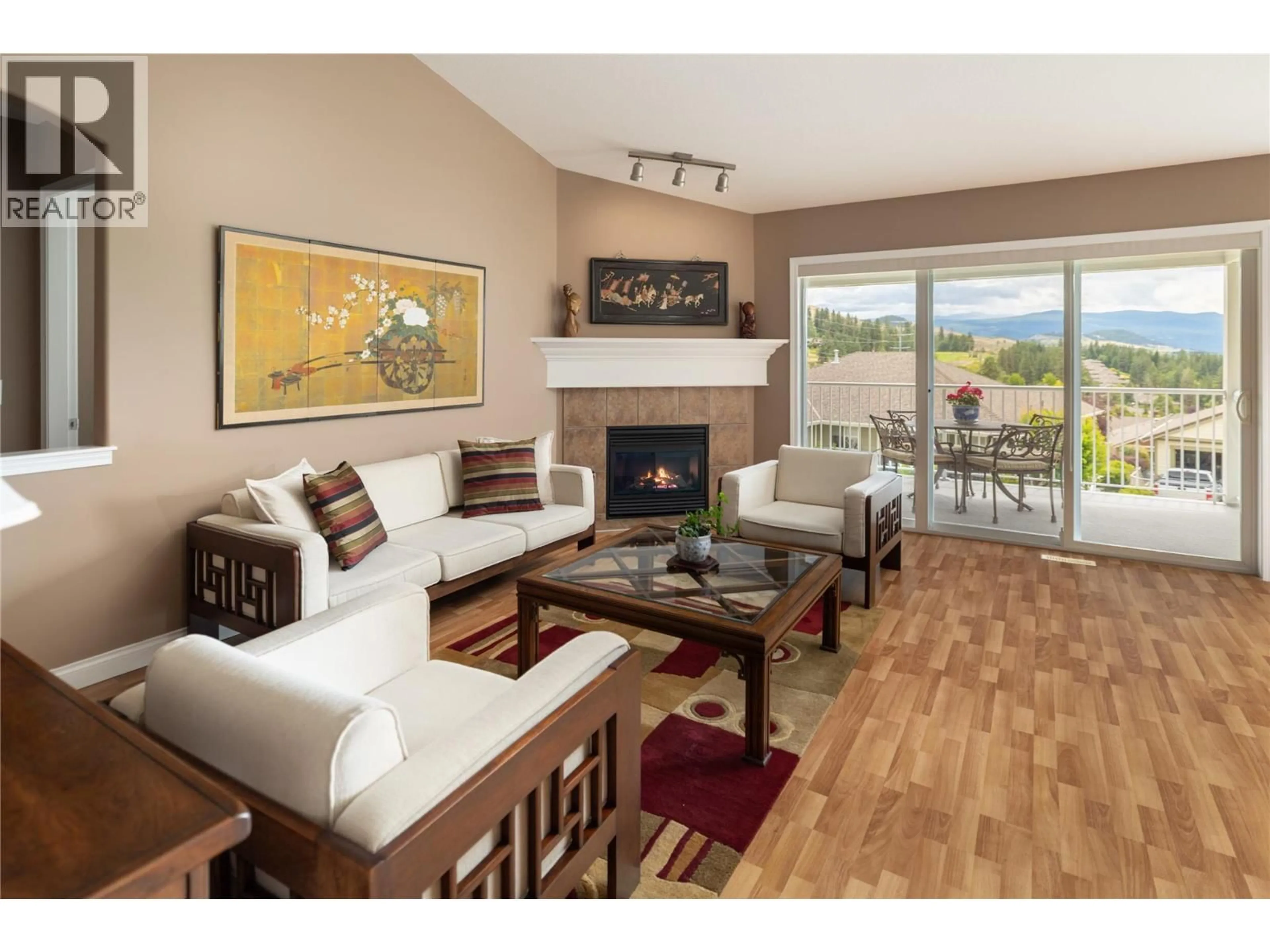 Living room with furniture, wood/laminate floor for 5175 SANDHILLS DRIVE, Kelowna British Columbia V1X7Y7