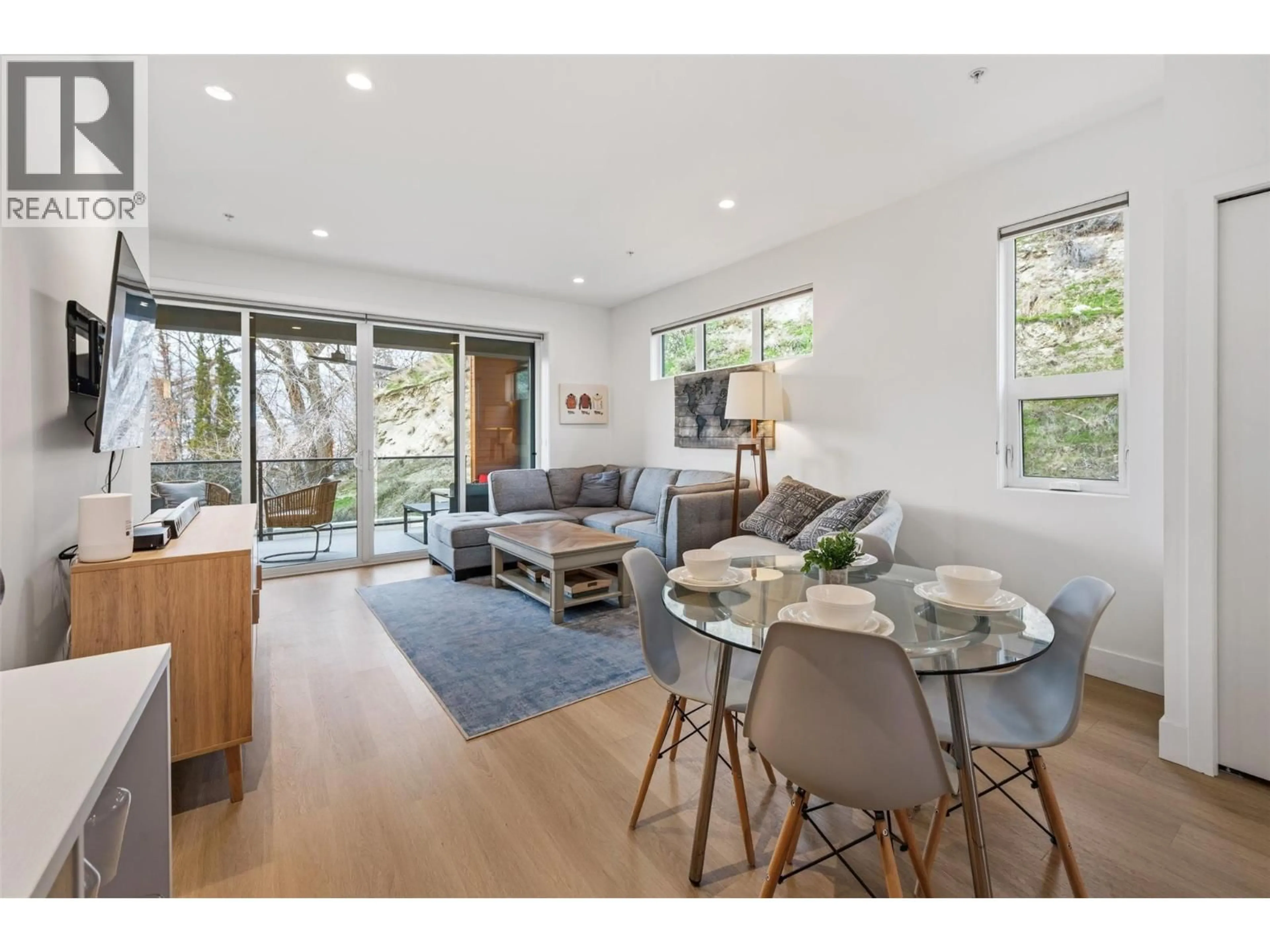 Living room with furniture, wood/laminate floor for 108 - 555 WADE AVENUE EAST, Penticton British Columbia V2A1T2