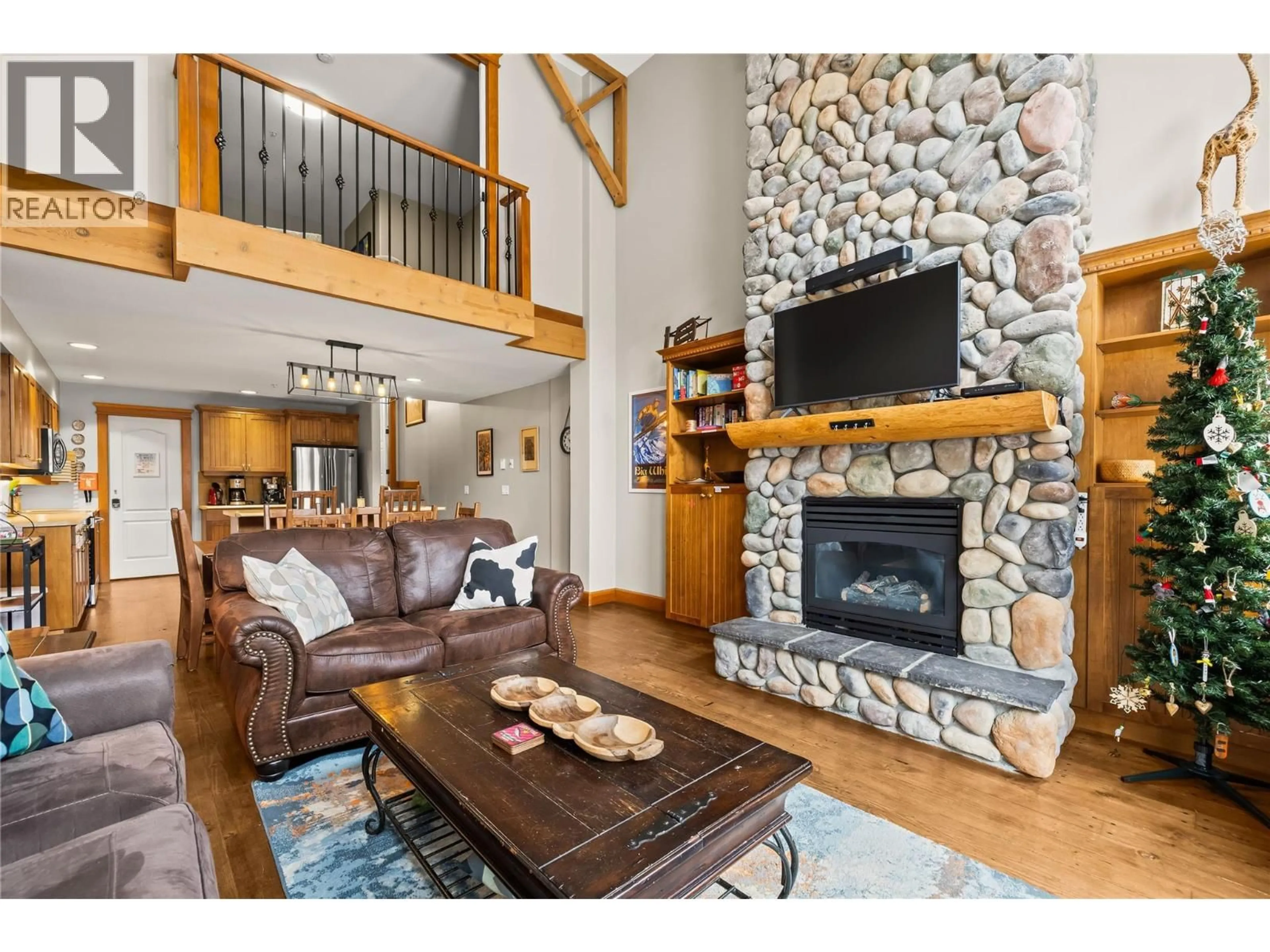 Living room with furniture, wood/laminate floor for 34 - 7640 PORCUPINE ROAD, Big White British Columbia V1P1T4