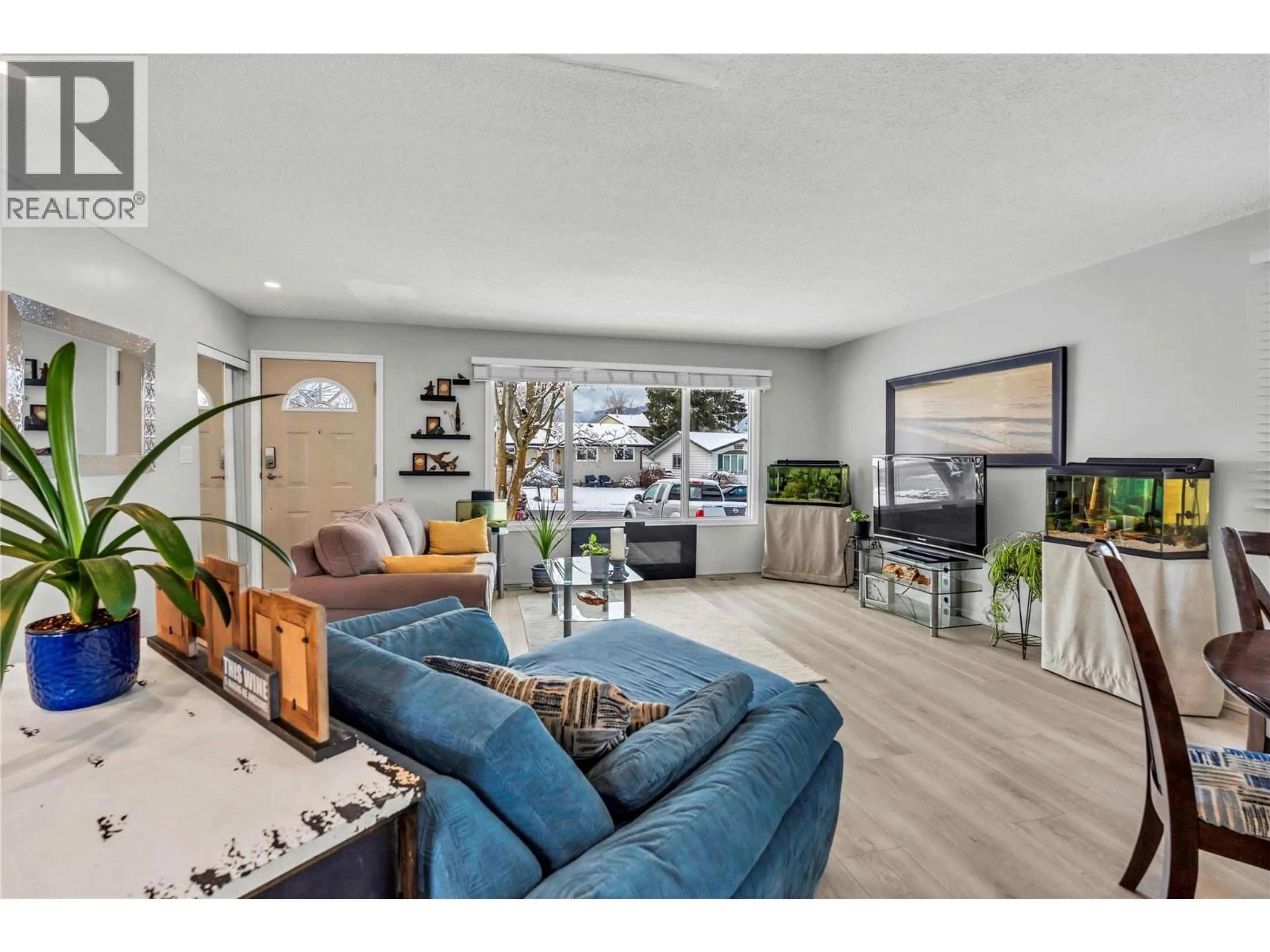 Living room with furniture, wood/laminate floor for 133 BRACEWELL DRIVE, Penticton British Columbia V2A6S3