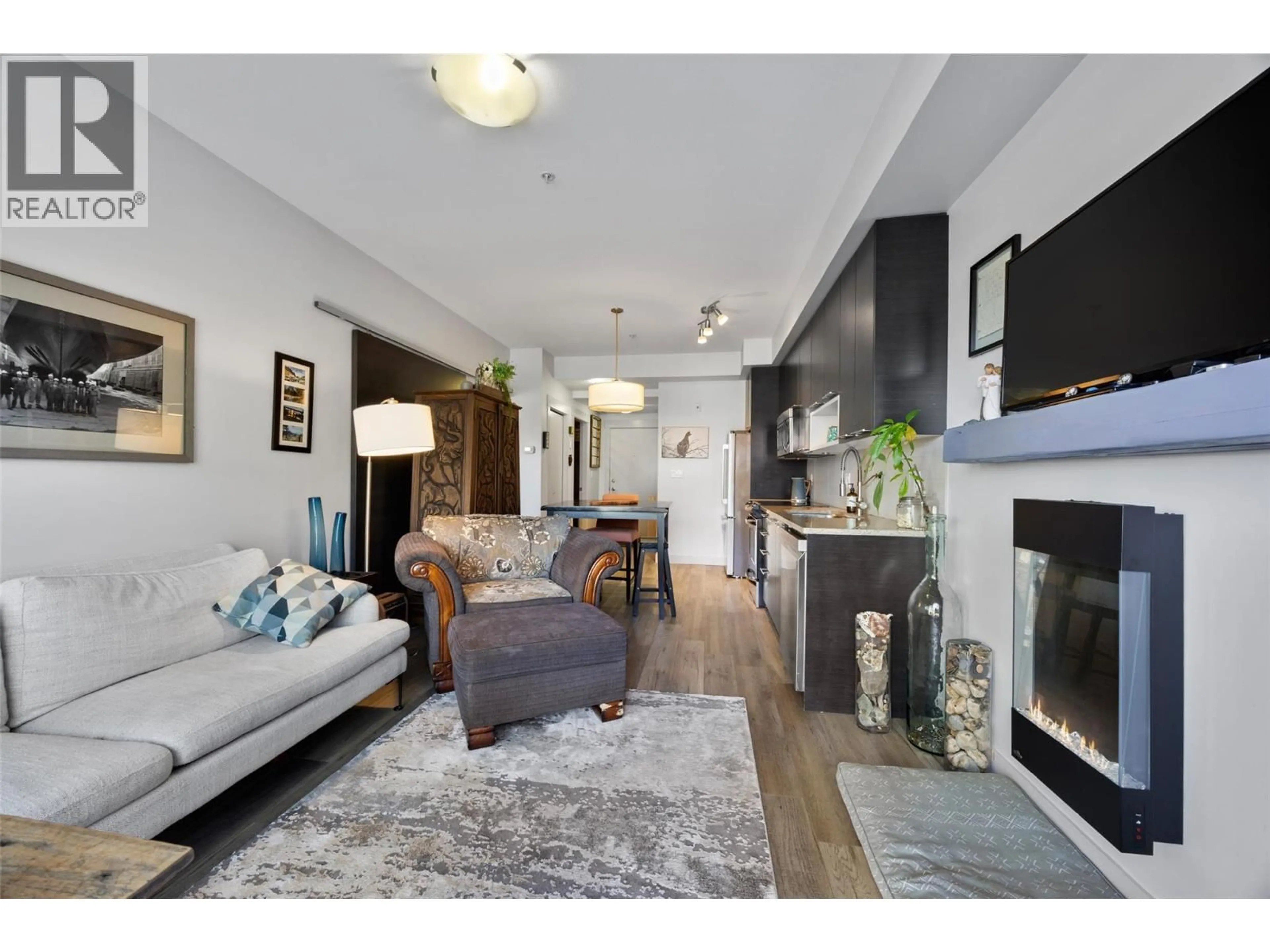 Living room with furniture, wood/laminate floor for 1306 - 1000 TALASA WAY, Kamloops British Columbia V2H0C2