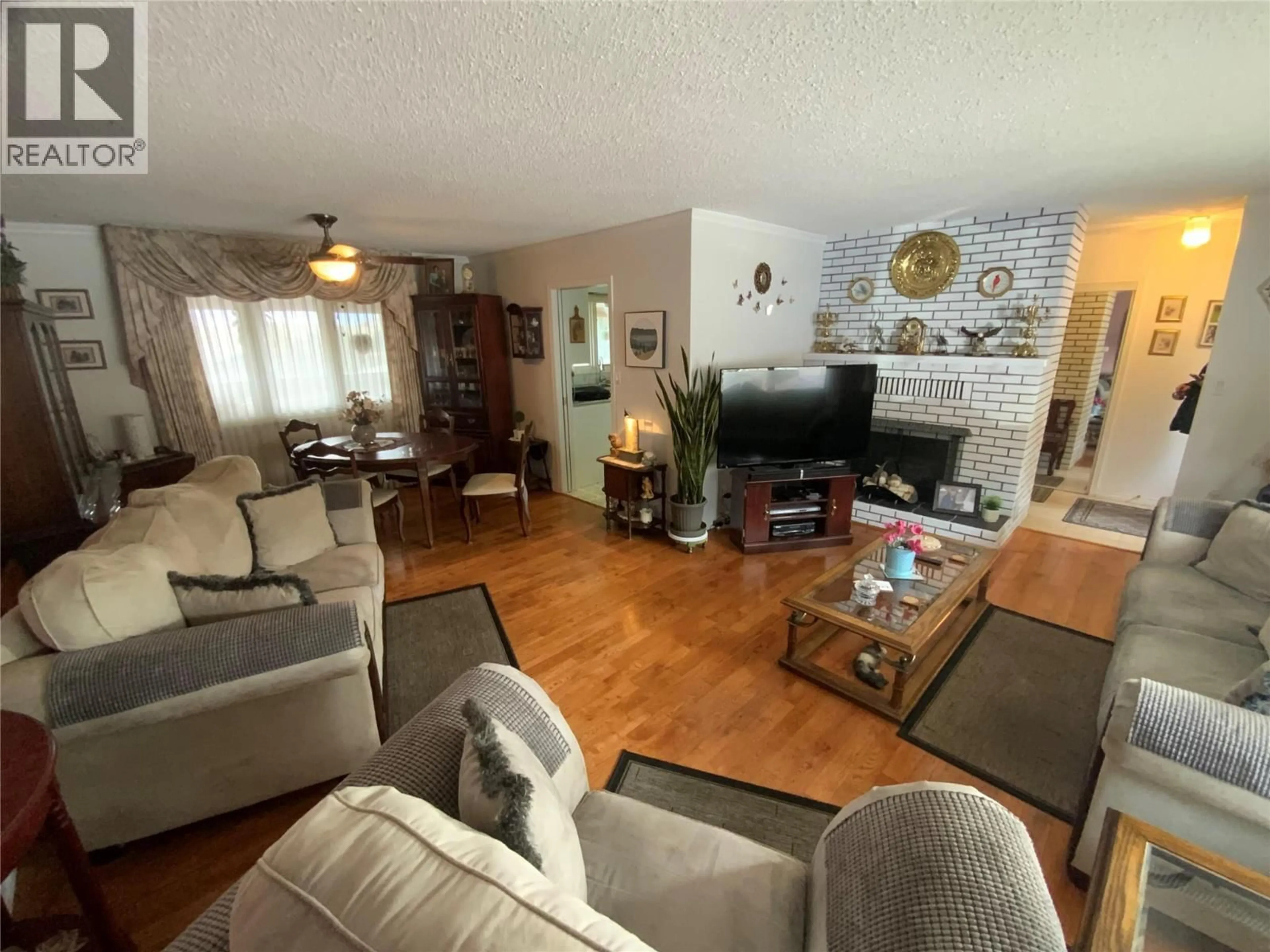 Living room with furniture, wood/laminate floor for 7805 GIANTS HEAD ROAD, Summerland British Columbia V0H1Z0