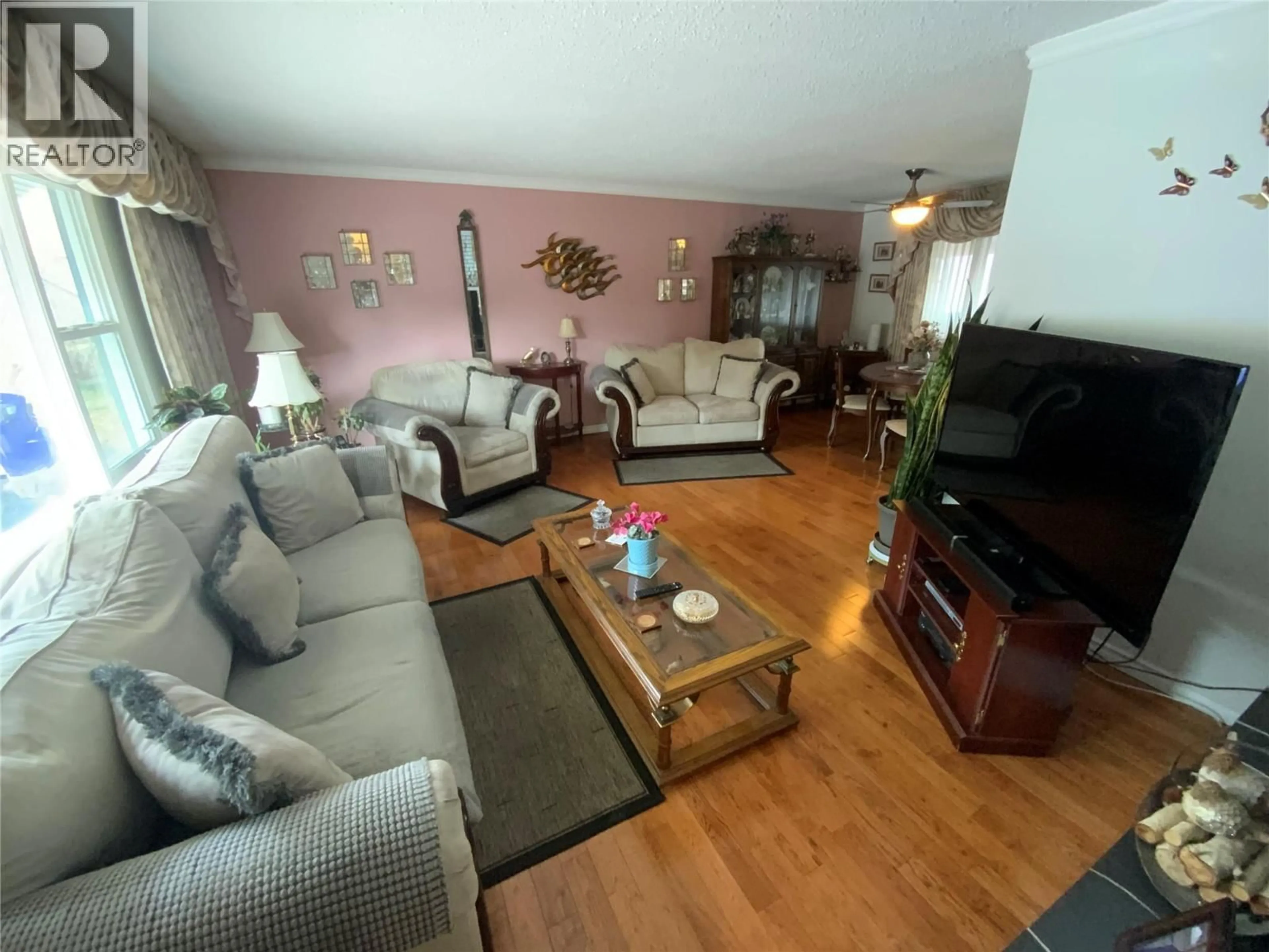Living room with furniture, wood/laminate floor for 7805 GIANTS HEAD ROAD, Summerland British Columbia V0H1Z0