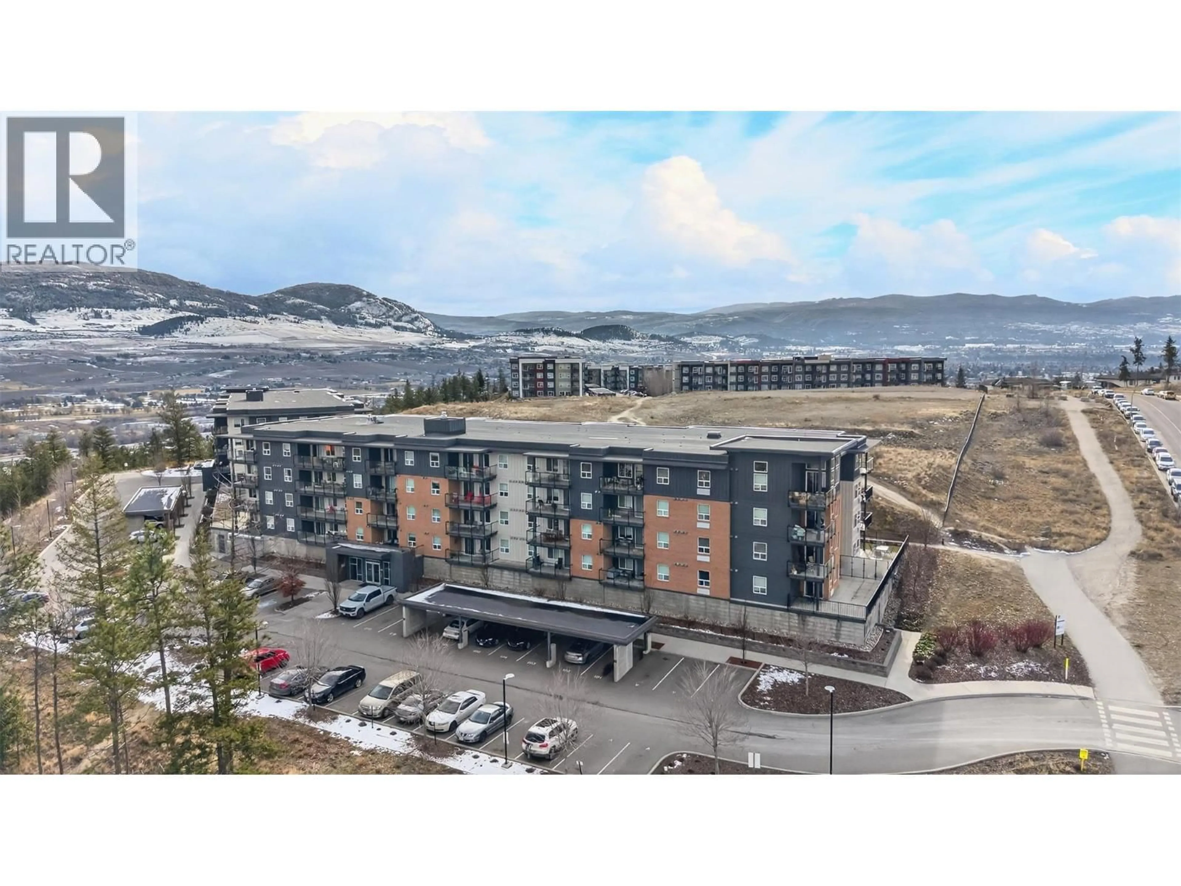 A pic from outside/outdoor area/front of a property/back of a property/a pic from drone, mountain view for 306 - 881 ACADEMY WAY, Kelowna British Columbia V1V0A2