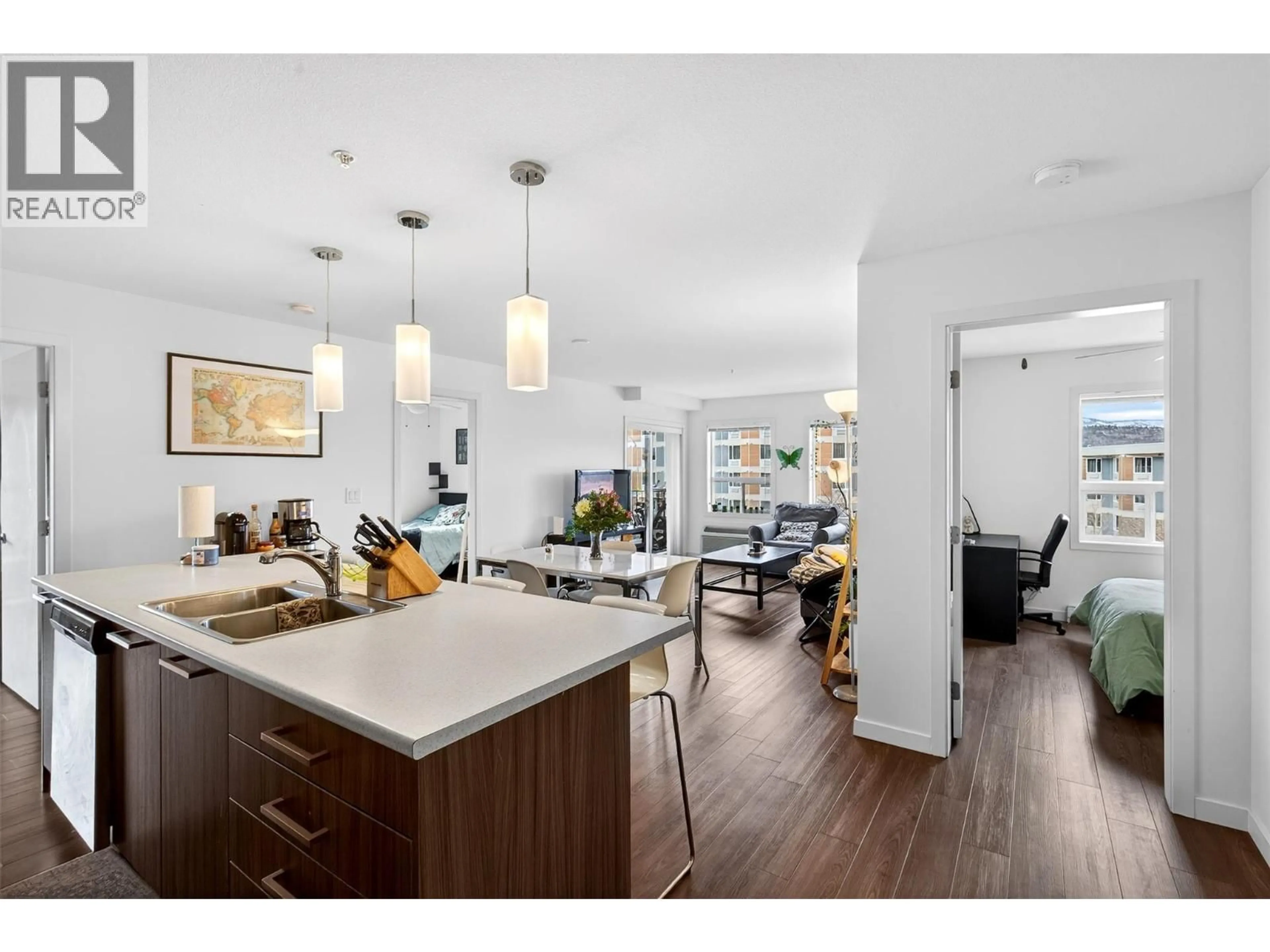 Open concept kitchen, wood/laminate floor for 306 - 881 ACADEMY WAY, Kelowna British Columbia V1V0A2