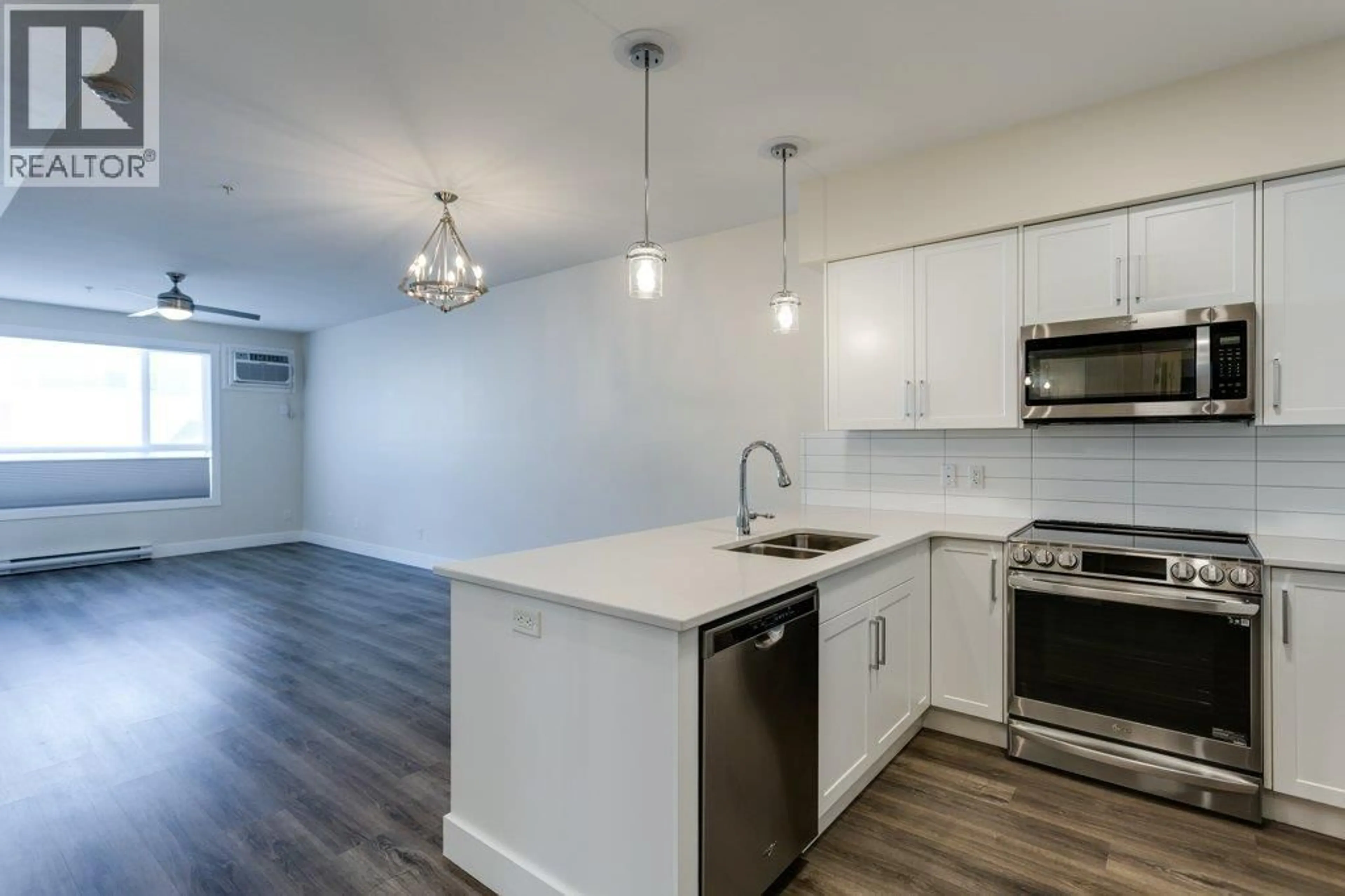 Open concept kitchen, wood/laminate floor for 104 - 3090 BURTCH ROAD, Kelowna British Columbia V1W5G9