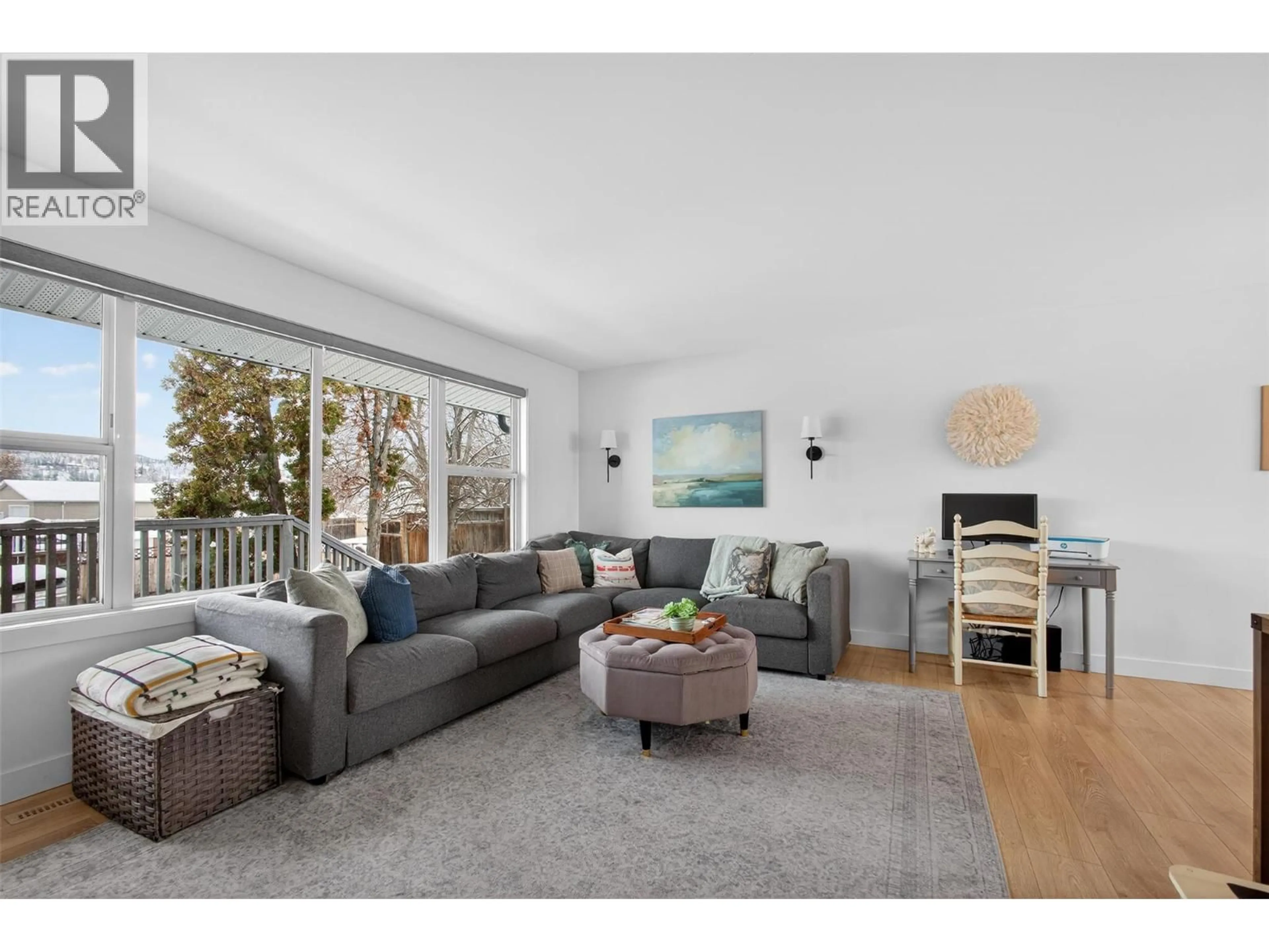 Living room with furniture, wood/laminate floor for 2490 SEXSMITH ROAD, Kelowna British Columbia V1V2E9