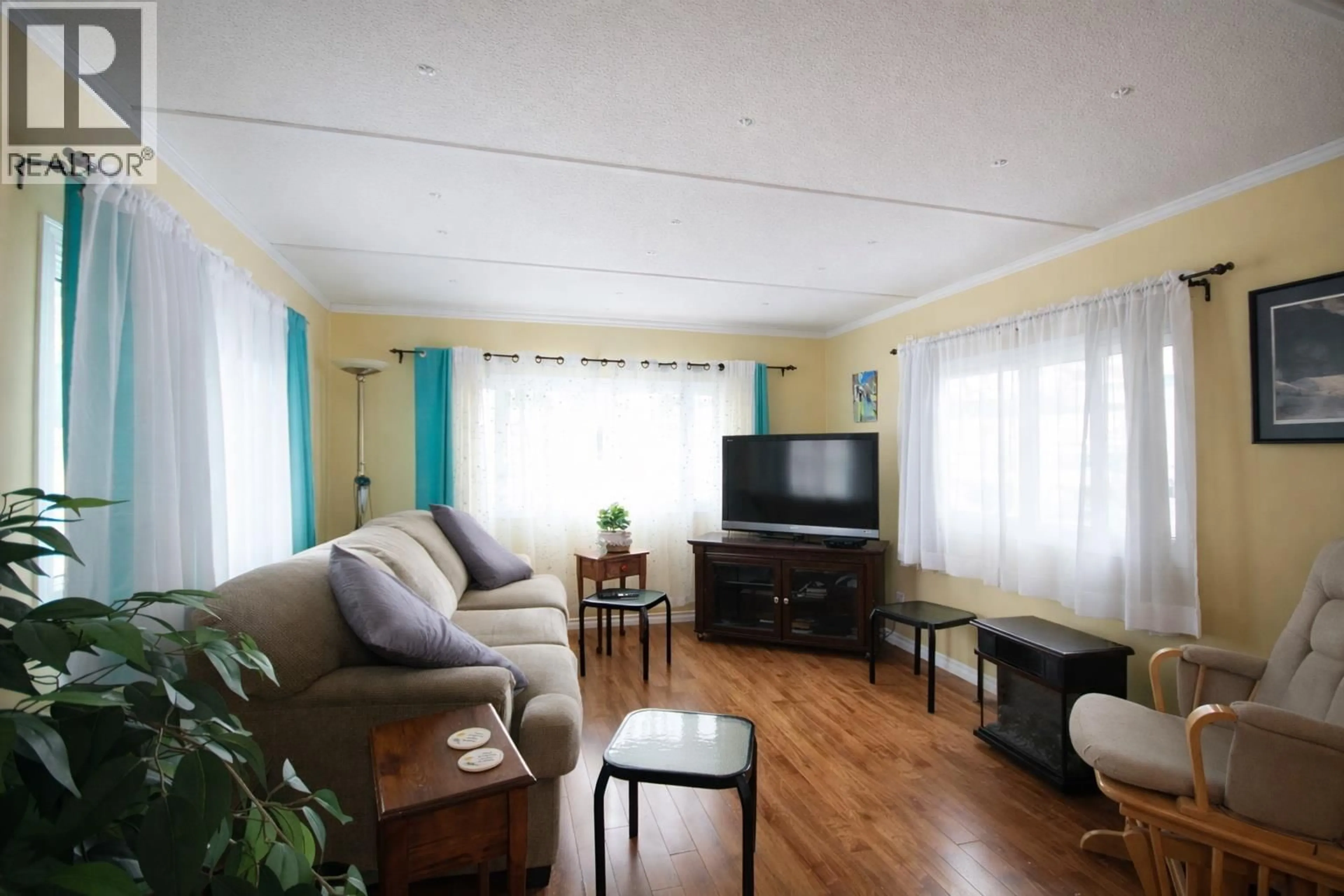 Living room with furniture, wood/laminate floor for 23 - 98 OKANAGAN AVENUE EAST, Penticton British Columbia V2A3J5