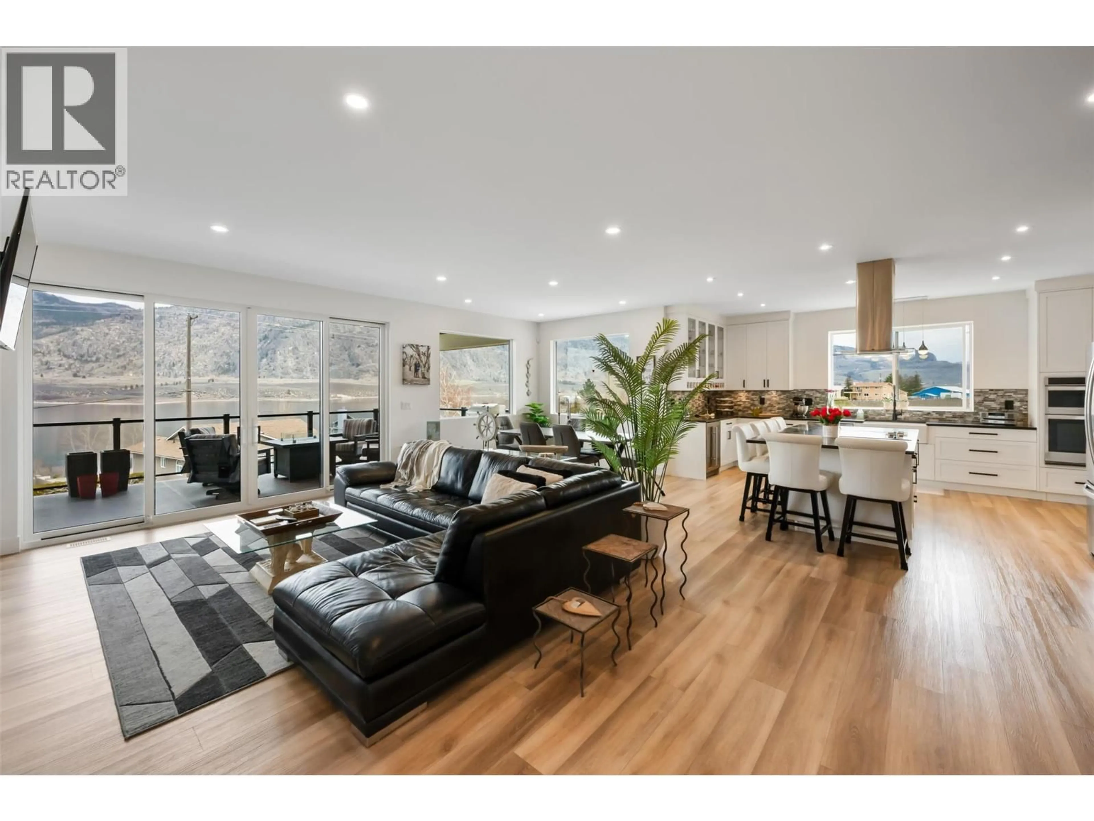 Living room with furniture, wood/laminate floor for 10400 87TH STREET, Osoyoos British Columbia V0H1V2