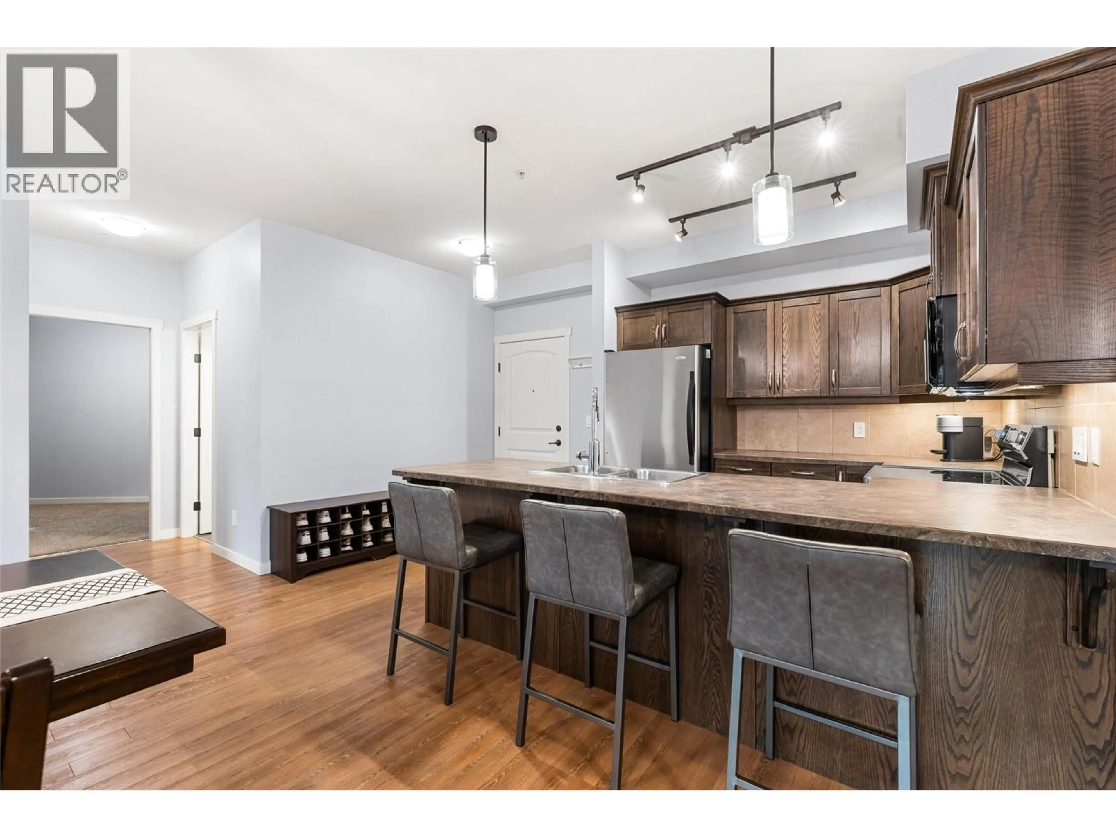 Open concept kitchen, wood/laminate floor for 101 - 3739 CASORSO ROAD, Kelowna British Columbia V1W5E8