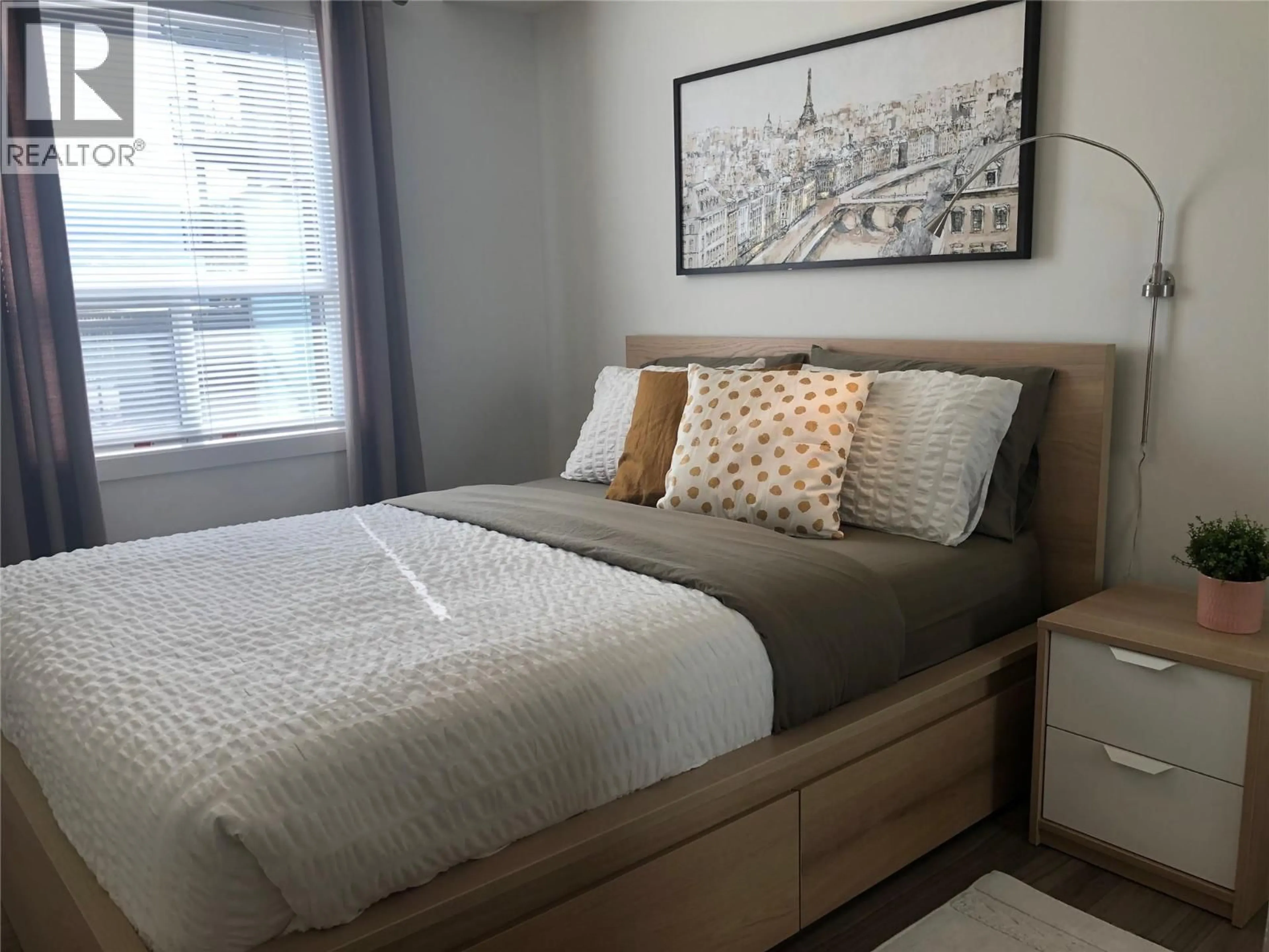 Bedroom with bed, wood/laminate floor for 115 - 881 ACADEMY WAY, Kelowna British Columbia V1V0A2